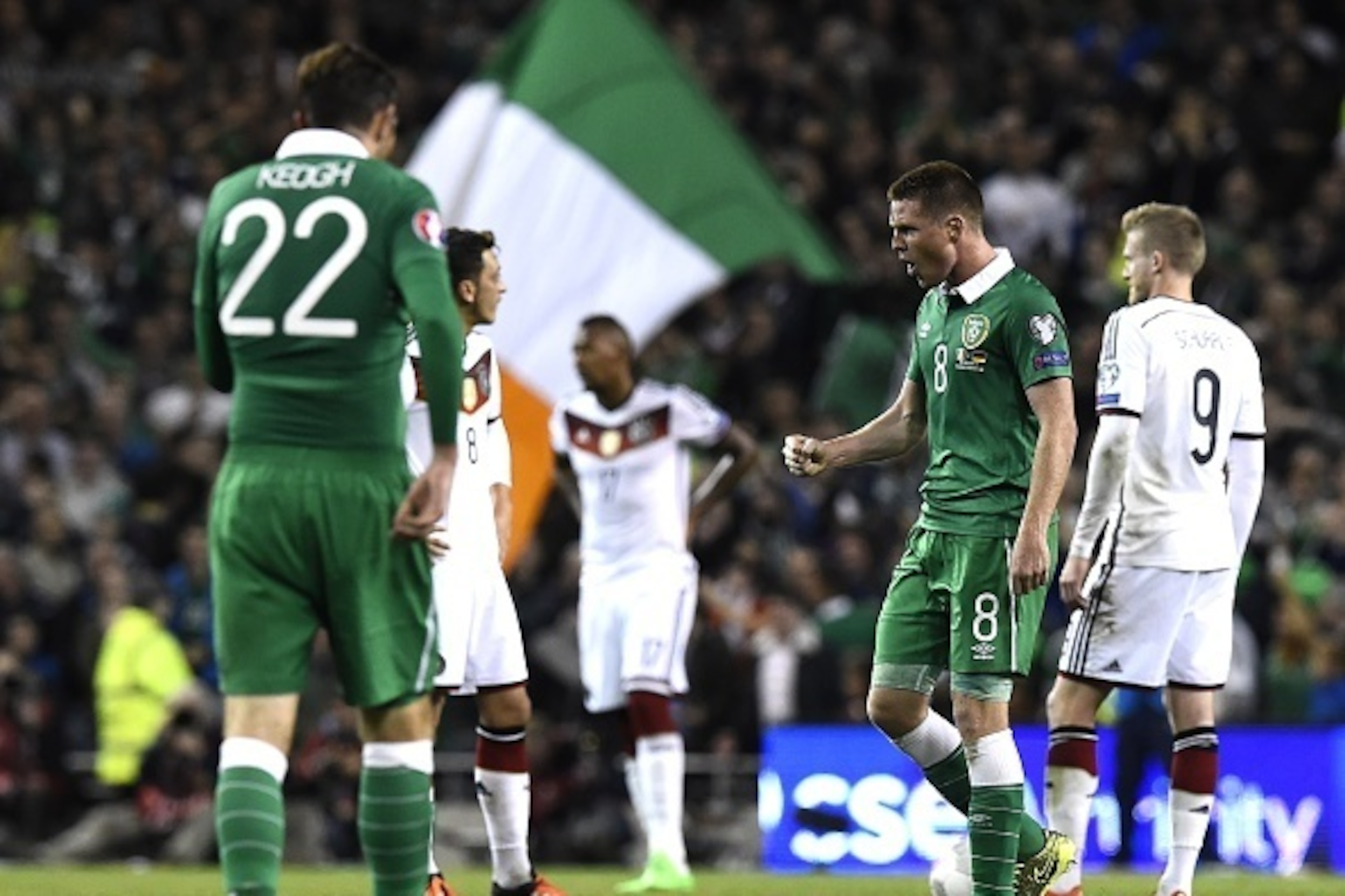 Republic of Ireland's midfielder James McCarthy (R) celebrates after Republic of Ireland's striker Shane Long scored a goal during a UEFA Euro 2016 Group D qualifying football match between Germany and Ireland at the Aviva stadium in Dublin on October 8, 