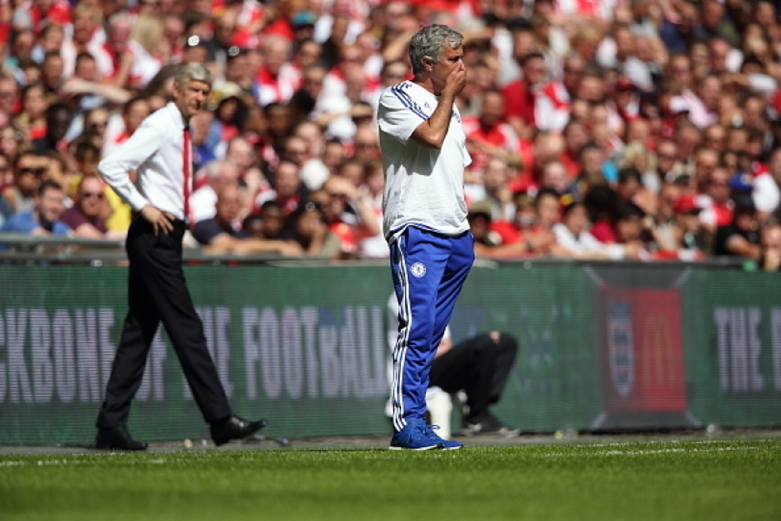 LONDON, ENGLAND -  AUGUST 2:  Arsene Wenger manager / head coach of Arsenal looks over at a worried Jose Mourinho the head coach / manager of Chelsea during the FA Community Shield match between Chelsea and Arsenal at Wembley Stadium on August 2, 2015 in 