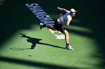 Andy Murray of Britain hits a return against John Isner of the US during their men's singles second round match at the Shanghai Masters tennis tournament in Shanghai on  October 15, 2015.  AFP PHOTO / JOHANNES EISELE        (Photo credit should read JOHAN