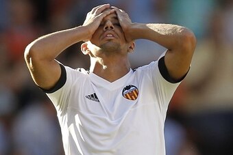 Valencia's French midfielder Sofiane Feghouli reacts after missing a goal during the Spanish league football match Valencia CF vs Real Betis Balompie at the Mestalla stadium in Valencia on September 19, 2015.   AFP PHOTO/ JOSE JORDAN        (Photo credit 