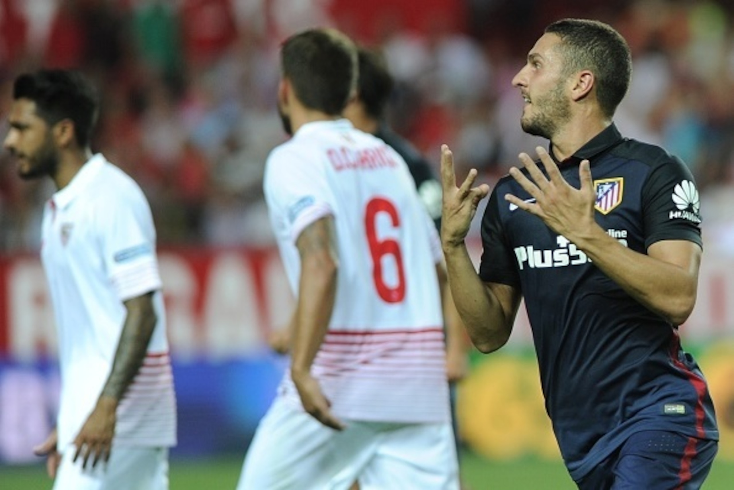 Atletico Madrid's midfielder Koke (R) celebrates after scoring during the Spanish league football match Sevilla FC vs Club Atletico de Madrid at the Ramon Sanchez Pizjuan stadium in Sevilla on August 30, 2015. AFP PHOTO/ CRISTINA QUICLER (Photo c Atletico Madrid's midfielder Koke (R) celebrates after scoring during the Spanish league football match Sevilla FC vs Club Atletico de Madrid at the Ramon Sanchez Pizjuan stadium in Sevilla on August 30, 2015. AFP PHOTO/ CRISTINA QUICLER (Photo c
