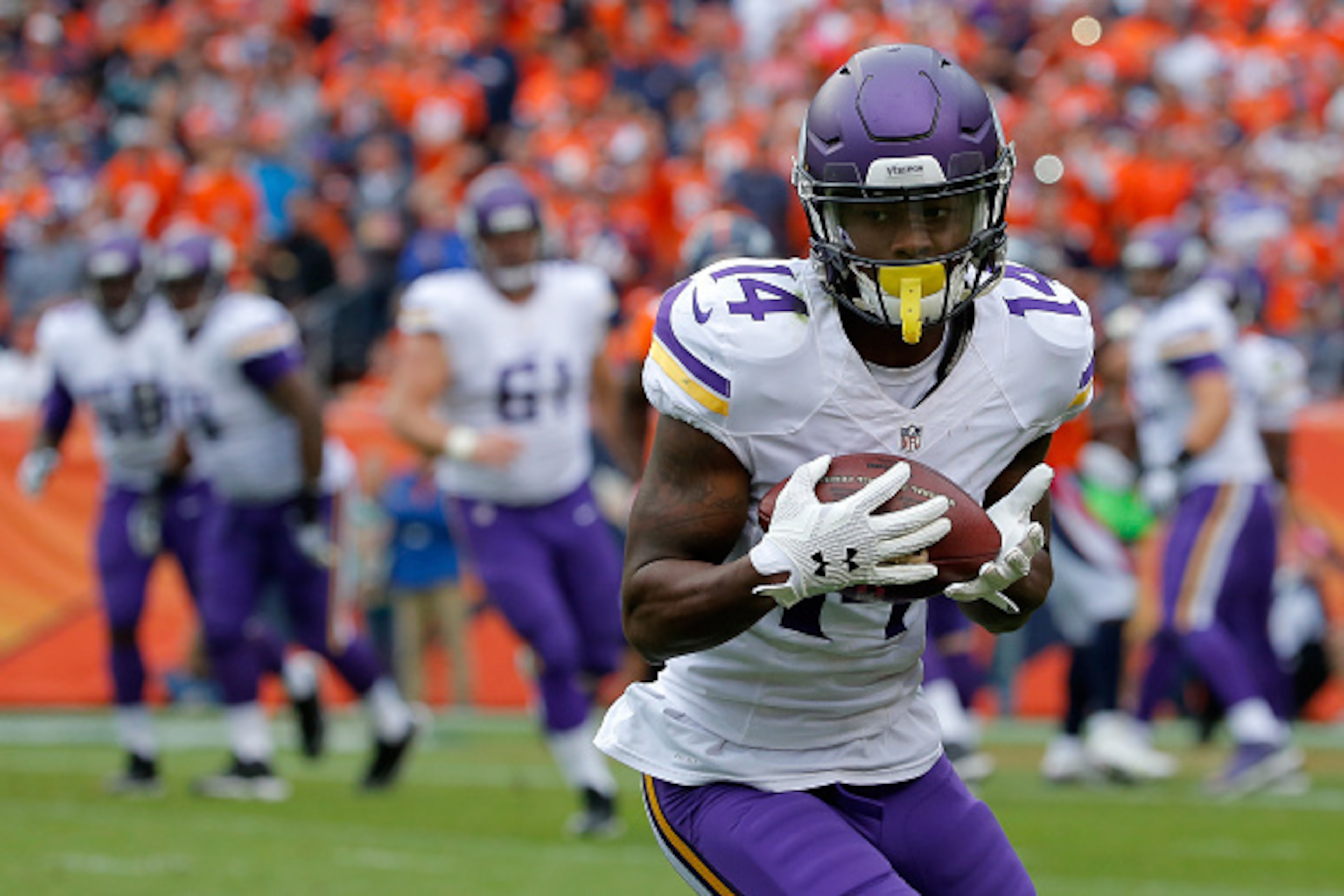 DENVER, CO - OCTOBER 04:  Wide receiver Stefon Diggs #14 of the Minnesota Vikings makes a pass reception against the Denver Broncos at Sports Authority Field at Mile High on October 4, 2015 in Denver, Colorado. The Broncos defeated the Vikings 23-20.  (Ph