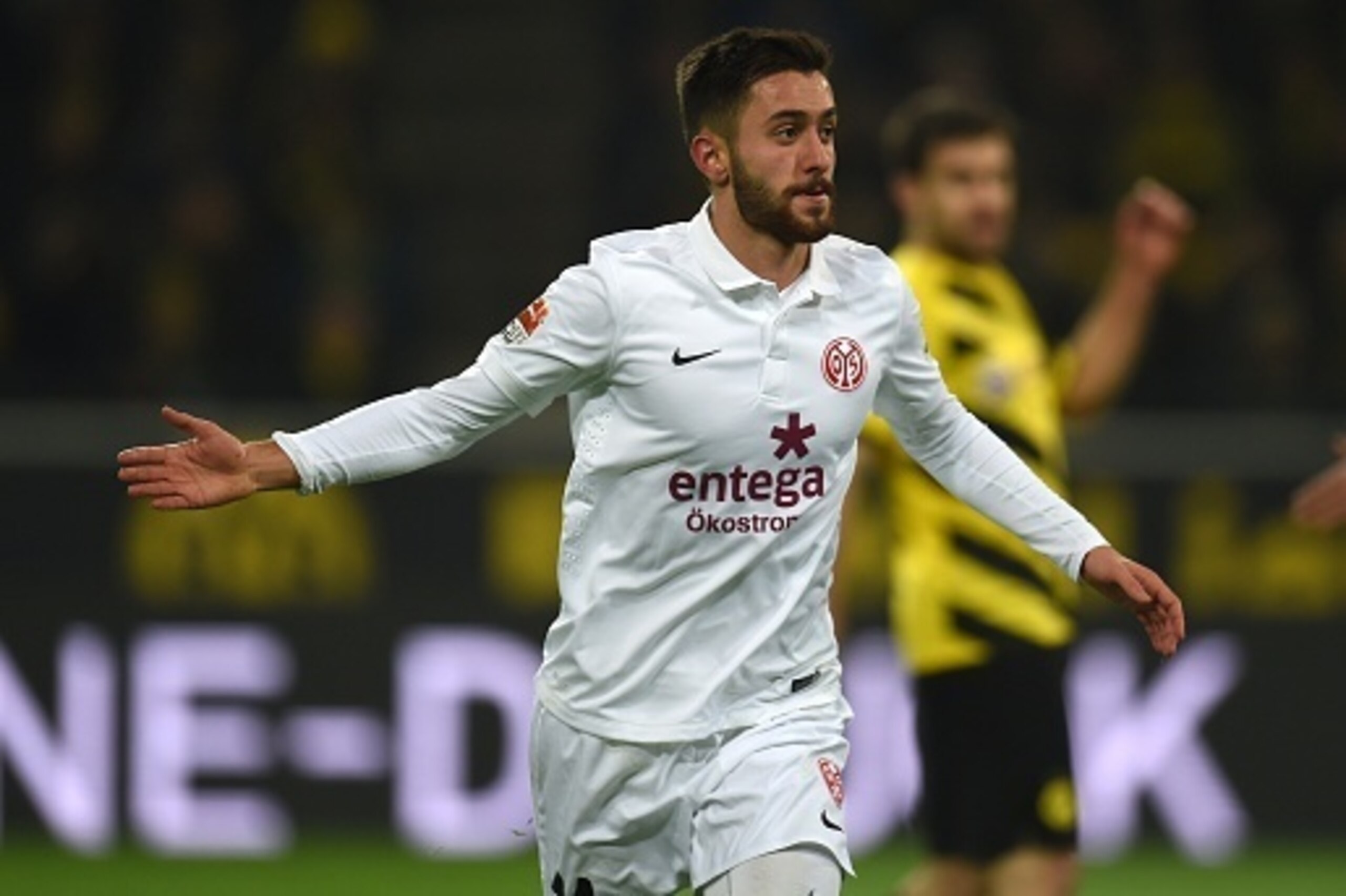 Mainz' midfielder Yunus Malli celebrates after scoring a second goal during the German first division Bundesliga football match Borussia Dortmund v 1 FSV Mainz 05 in Dortmund, Germany, on February 13, 2015.  AFP PHOTO /  PATRIK STOLLARZ

DFL RULES TO LIMI