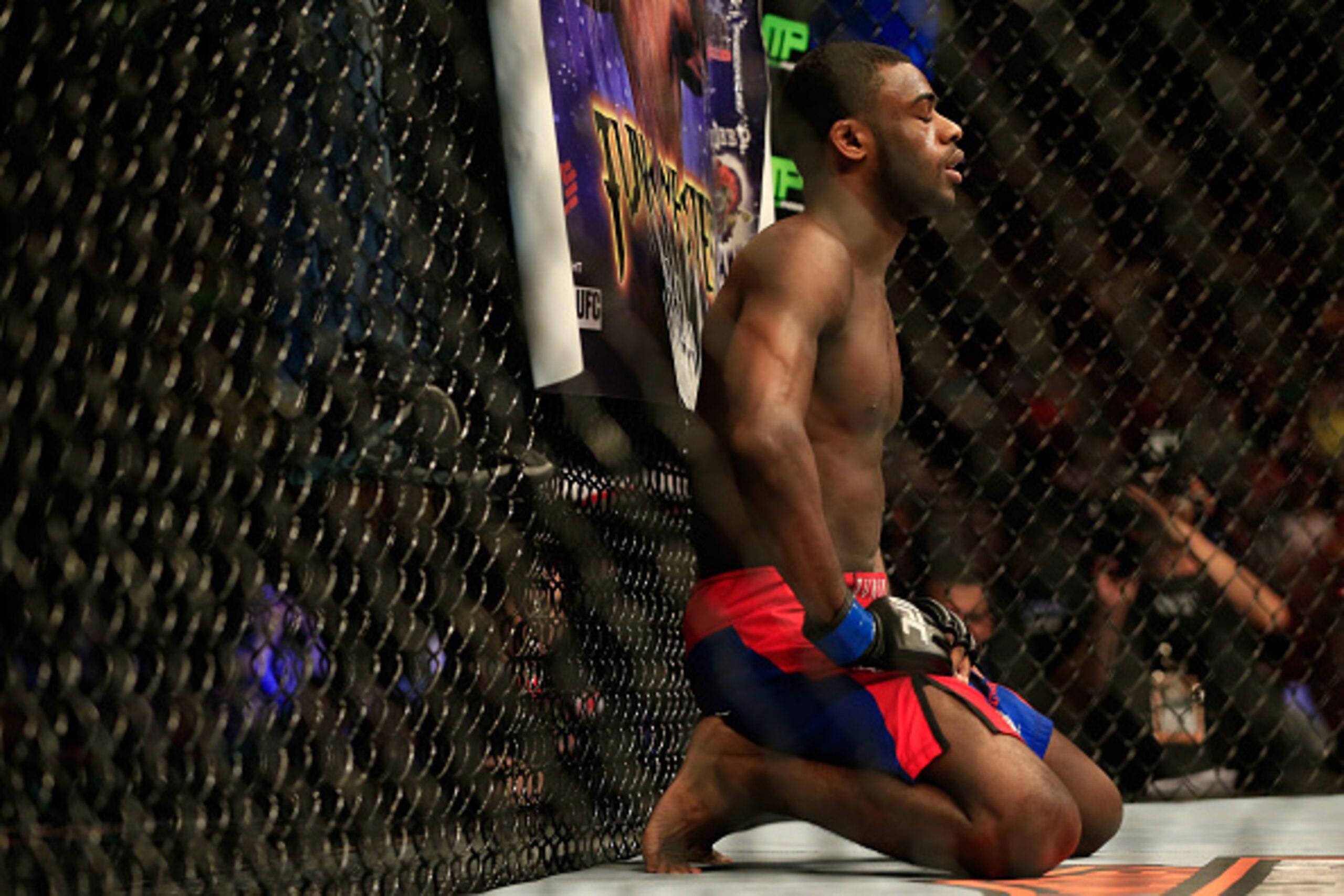 NEWARK, NJ - APRIL 18:  Aljamain Sterling (blue shorts) takes a moment against Takeya Mizugaki of Japan (white and black shorts)  before their bantamweight bout during the UFC Fight Night event at Prudential Center on April 18, 2015 in Newark, New Jersey.