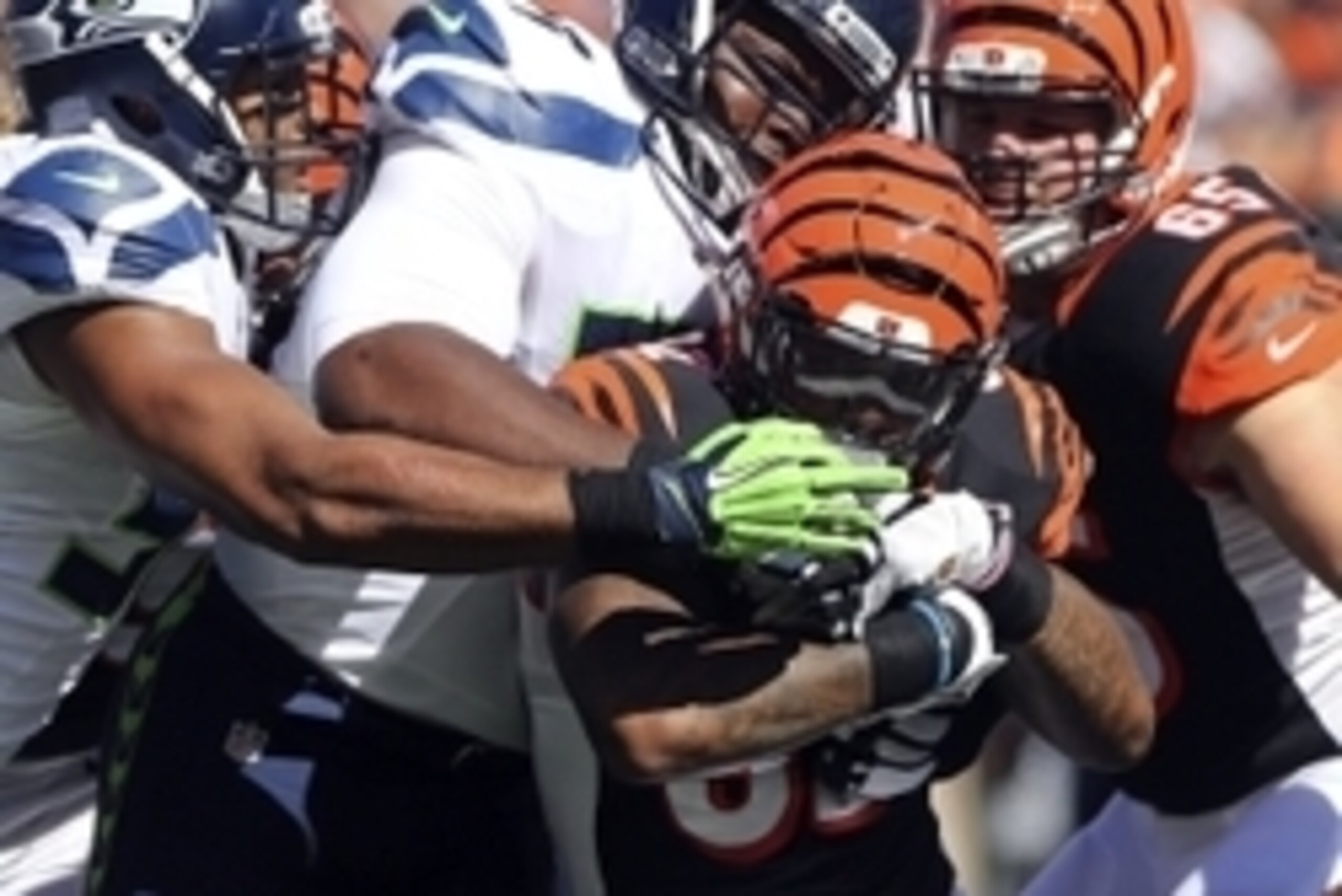 Oct 11, 2015; Cincinnati, OH, USA; Cincinnati Bengals running back Jeremy Hill (32) is tackled by Seattle Seahawks defensive tackle Ahtyba Rubin (77) in the first half at Paul Brown Stadium. Mandatory Credit: Aaron Doster-USA TODAY Sports