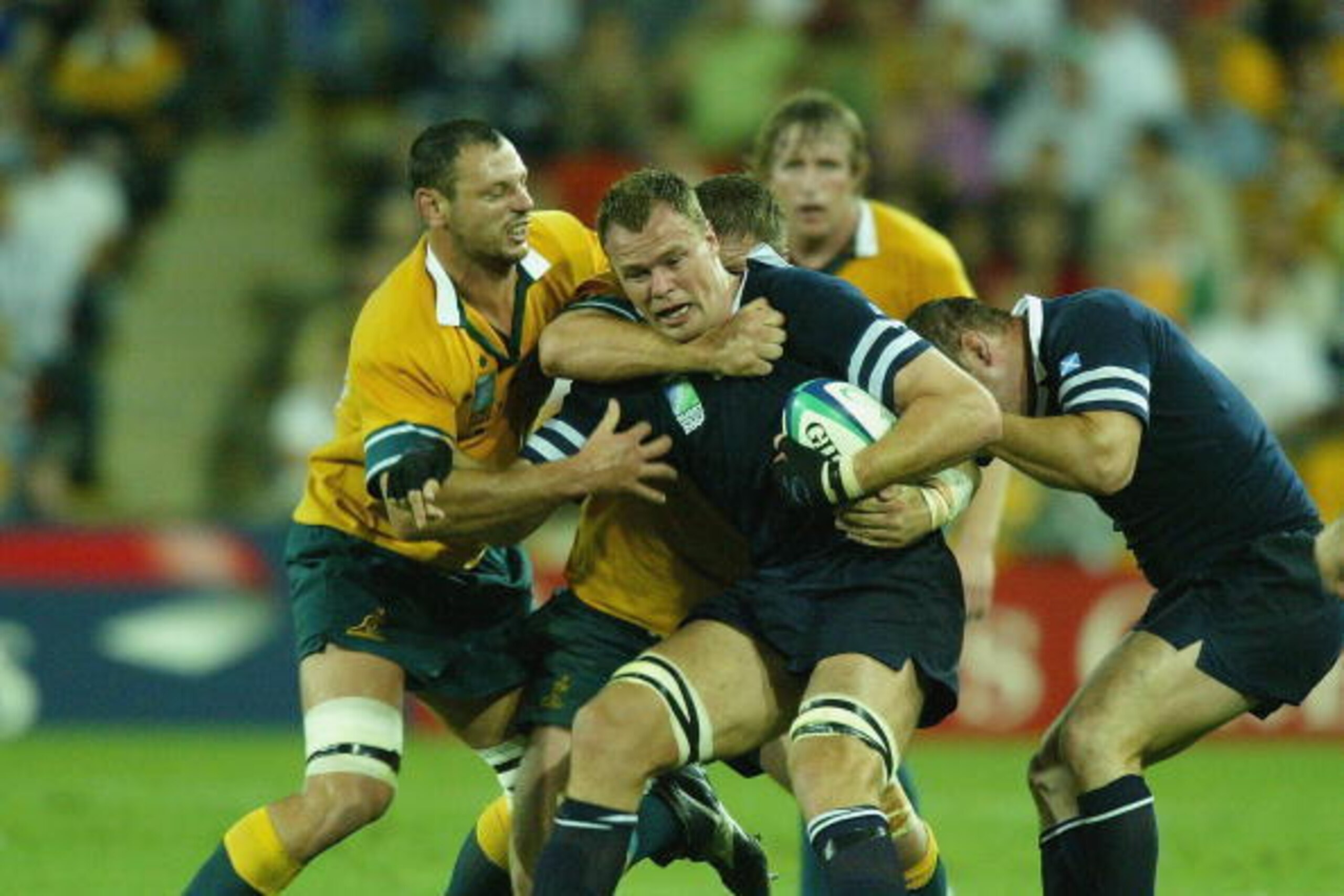 BRISBANE, AUSTRALIA - NOVEMBER 8:  Stuart Grimes of Scotland is held by the Australian defence during the Rugby World Cup Quarter Final match between Australia and Scotland at Suncorp Stadium November 8, 2003 in Brisbane, Australia. (Photo by David Rogers