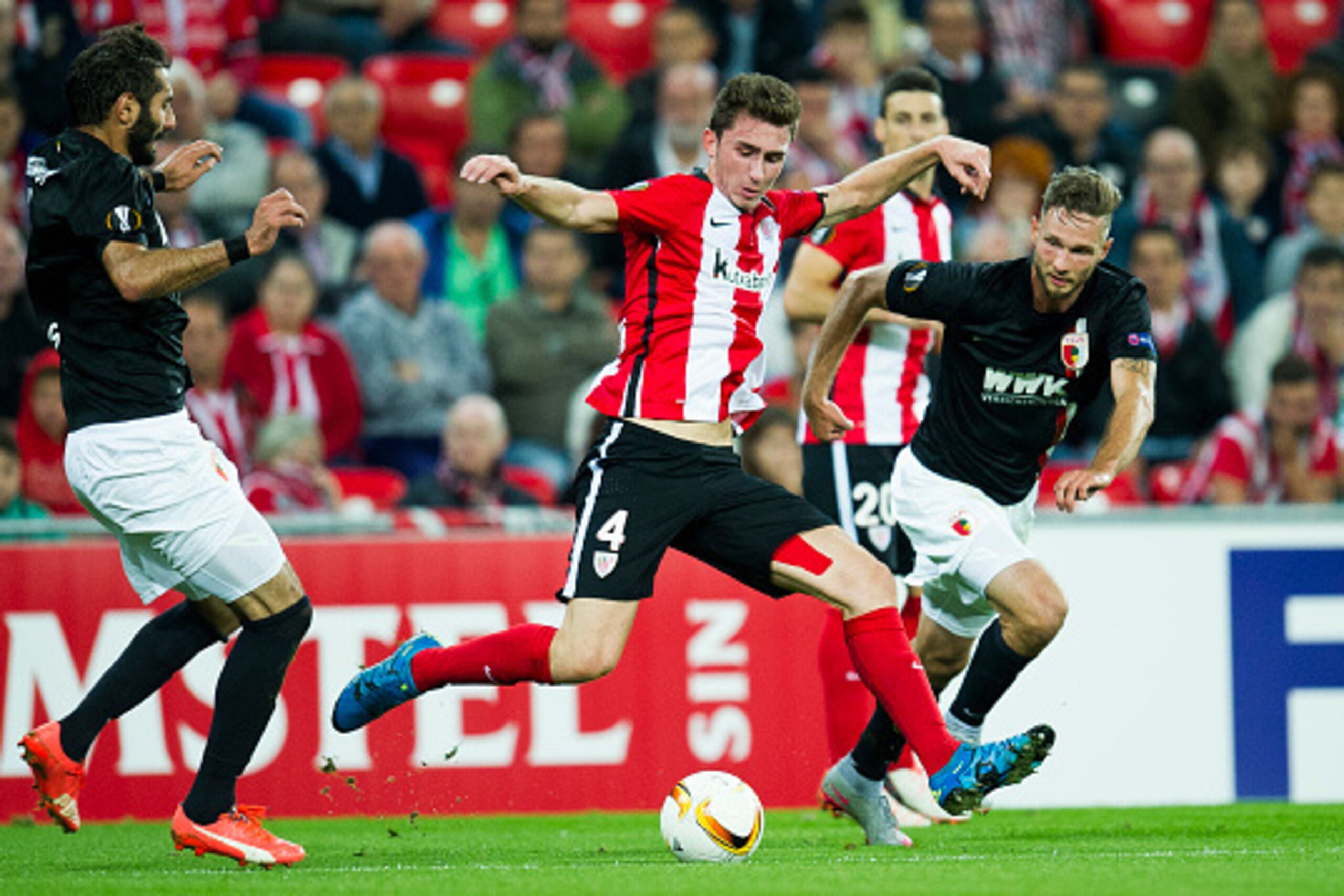 BILBAO, SPAIN - SEPTEMBER 17: Aimeric Laporte of Athletic Club duels for the ball with Halil Altontop of FC Augsburg during the UEFA Europa League match between Athletic Club and FC Augsburg at San Mames Stadium on September 17, 2015 in Bilbao, Spain.  (P