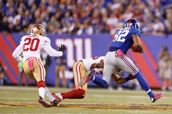 EAST RUTHERFORD, NJ - OCTOBER 11: Eric Reid #35 of the San Francisco 49ers tackles Odell Beckham Jr. #13 of the New York Giants during the game at MetLife Stadium on October 11, 2015 in East Rutherford, New Jersey. The Giants defeated the 49ers 30-27. (Ph