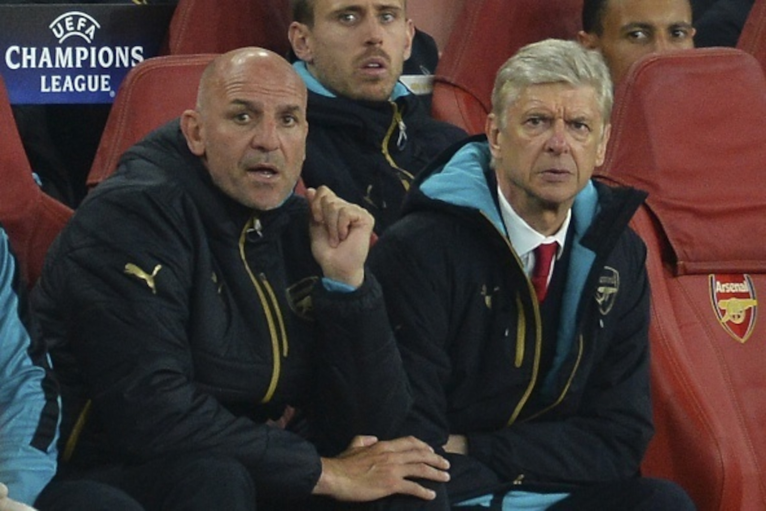 Arsenal's French manager Arsene Wenger (R) and assistant manager Steve Bould (L) react as they watch the action from the dug out during the UEFA Champions League Group F football match between Arsenal and Olympiakos at The Emirates Stadium in north London