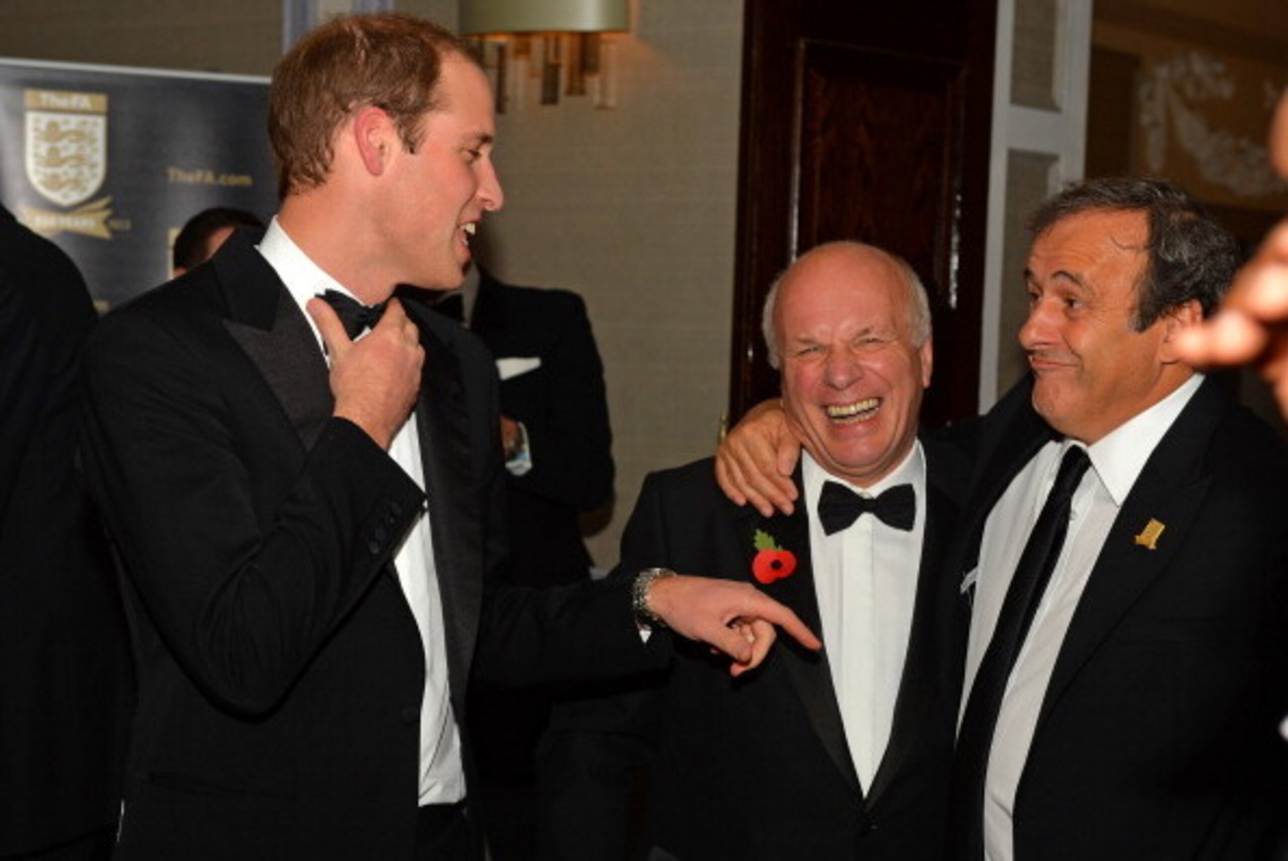 Britain's Prince William, Duke of Cambridge (L) shares a joke with FA Chairman Greg Dyke (C) and UEFA President Michel Platini (R) as he attends The Football Association's 150th Anniversary Gala Dinner at the Grand Connaught Rooms in central London on Oct