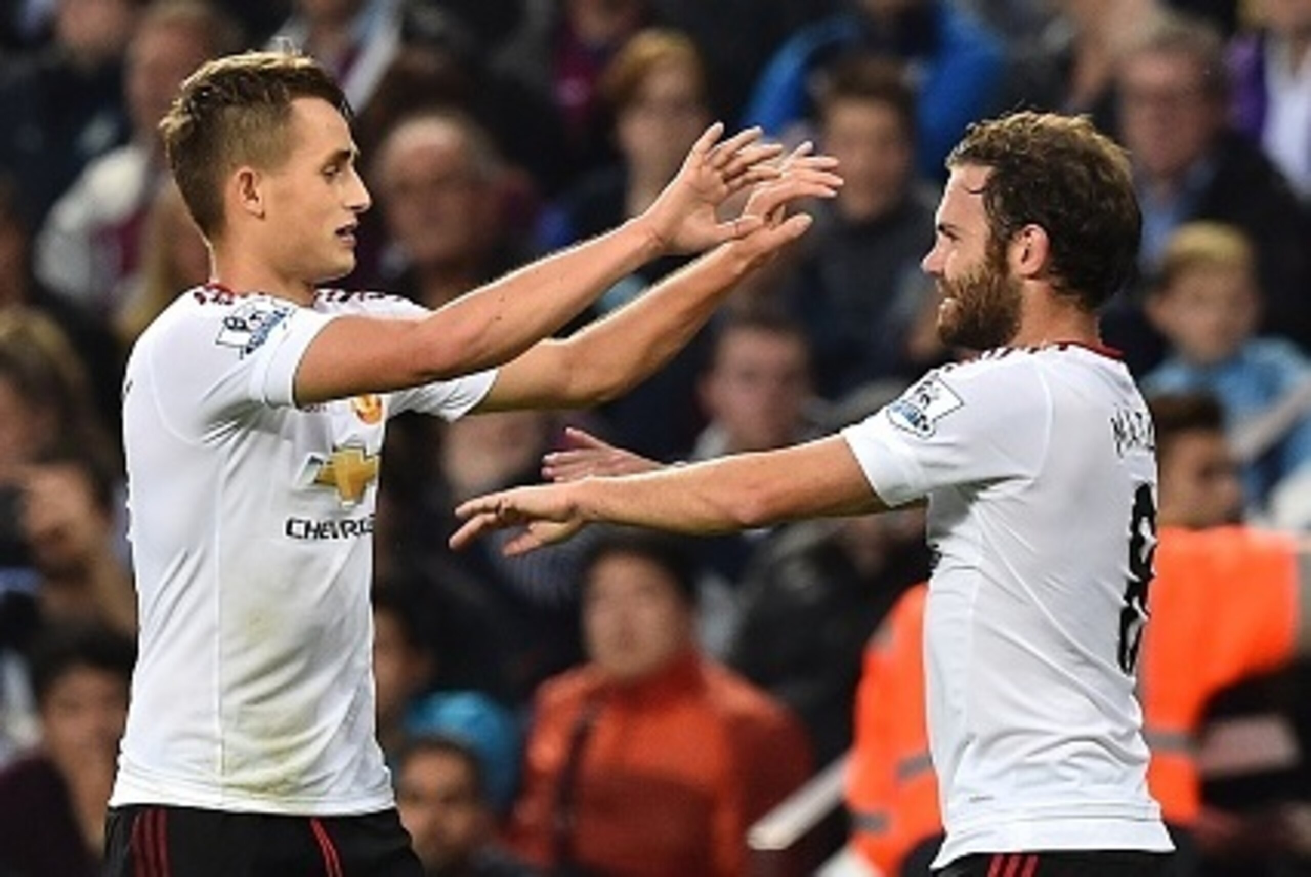 Manchester United's Belgian midfielder Adnan Januzaj (L) celebrates with Manchester United's Spanish midfielder Juan Mata after he scored his team's first goal during the English Premier League football match between Aston Villa and Manchester United at V