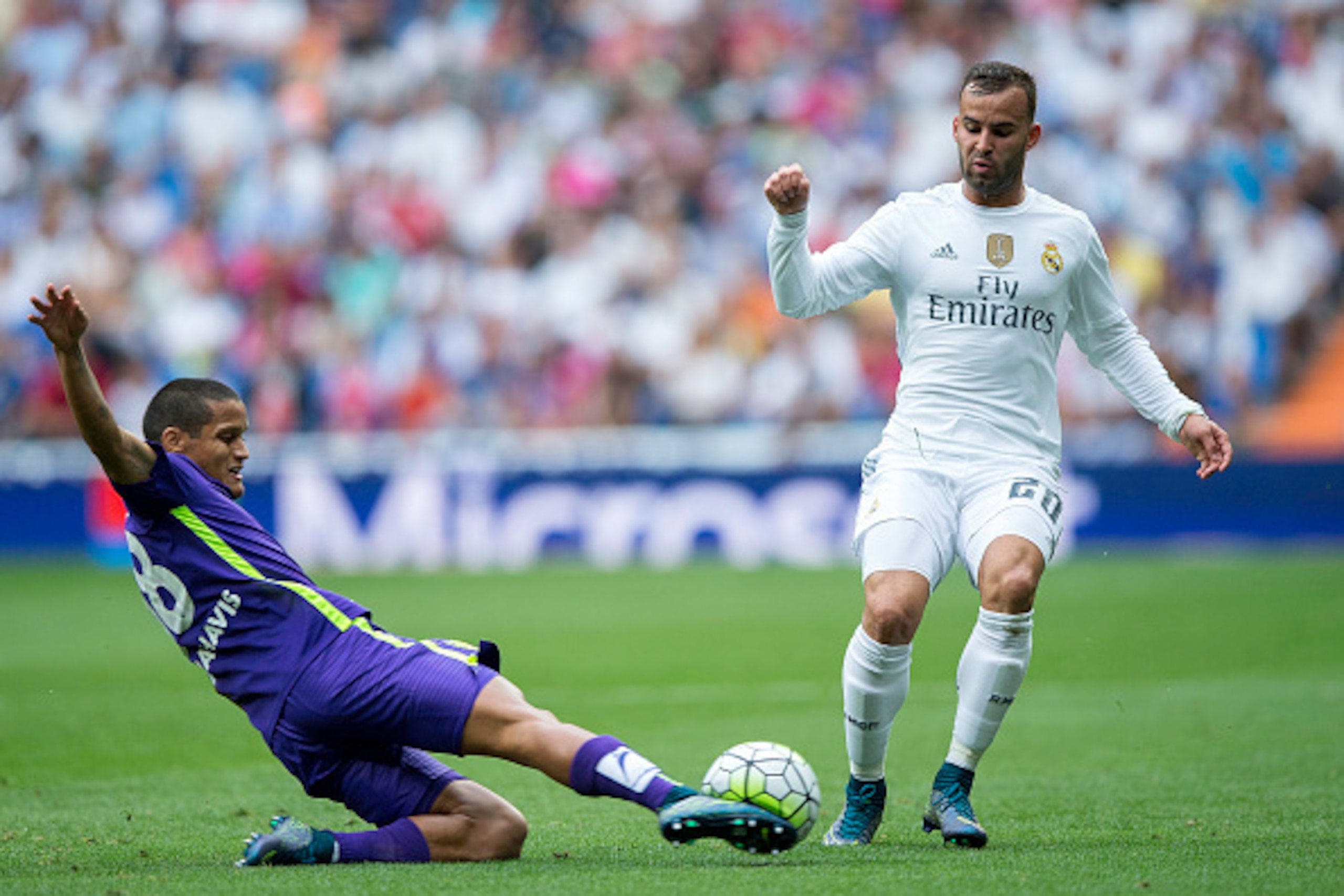 MADRID, SPAIN - SEPTEMBER 26: Roberto Rosales (L) of Malaga CF competes for the ball with Jese Rodriguez (R) of Real Madrid CF during the La Liga match between Real Madrid CF and Malaga CF at Estadio Santiago Bernabeu on September 26, 2015 in Madrid, Spai