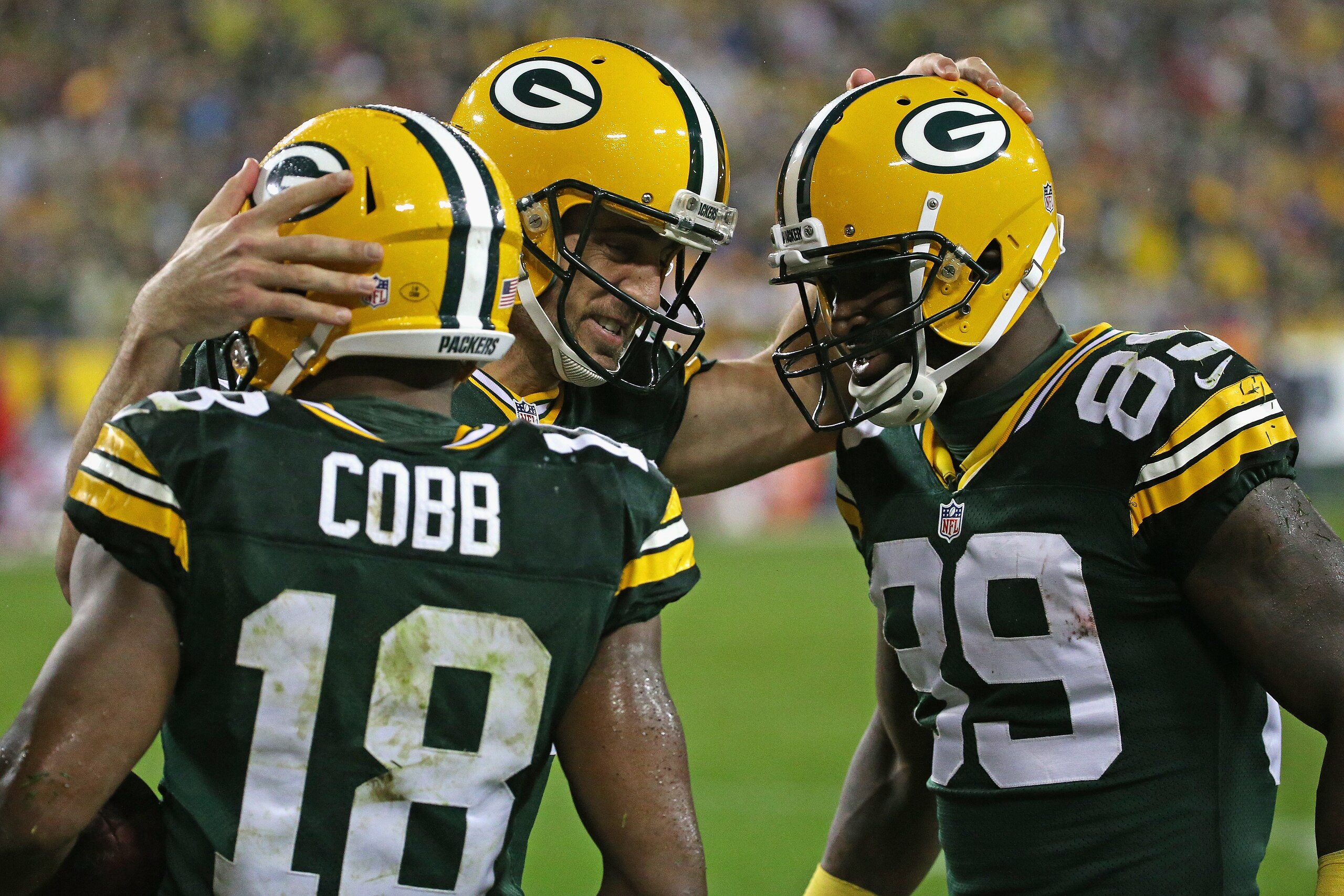 GREEN BAY, WI - SEPTEMBER 28: Aaron Rodgers #12 of the Green Bay Packers congratulates Randall Cobb #18 and James Jones #89 after a touchdown against the Kansas City Chiefs at Lambeau Field on September 28, 2015 in Green Bay, Wisconsin. The Packers defeat
