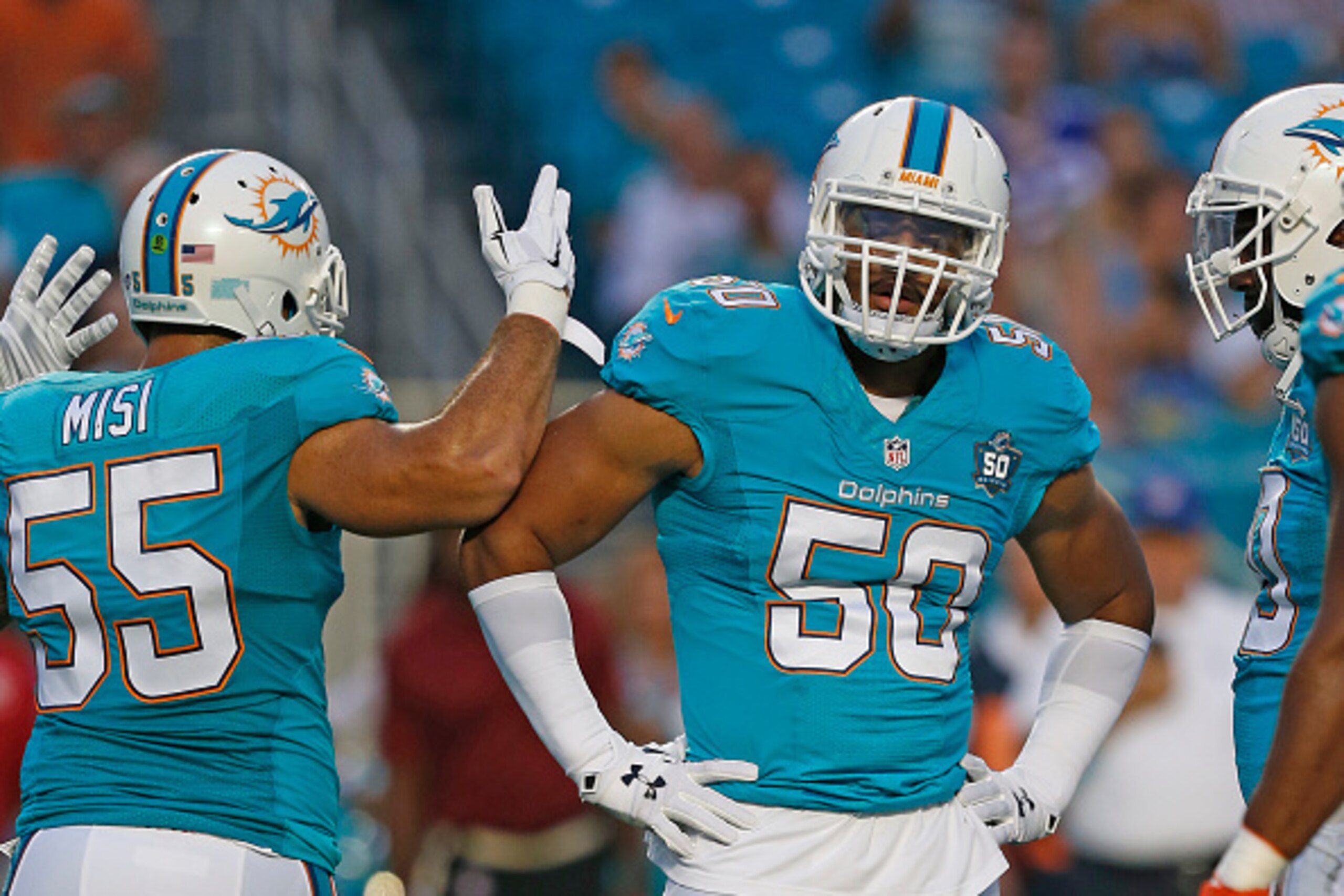 MIAMI GARDENS, FL - AUGUST 29: Koa Misi #55 talks to Olivier Vernon #50 of the Miami Dolphins between plays against the Atlanta Falcons during a preseason game on August 29, 2015 at Sun Life Stadium in Miami Gardens, Florida. The Dolphins defeated the Fal MIAMI GARDENS, FL - AUGUST 29: Koa Misi #55 talks to Olivier Vernon #50 of the Miami Dolphins between plays against the Atlanta Falcons during a preseason game on August 29, 2015 at Sun Life Stadium in Miami Gardens, Florida. The Dolphins defeated the Fal