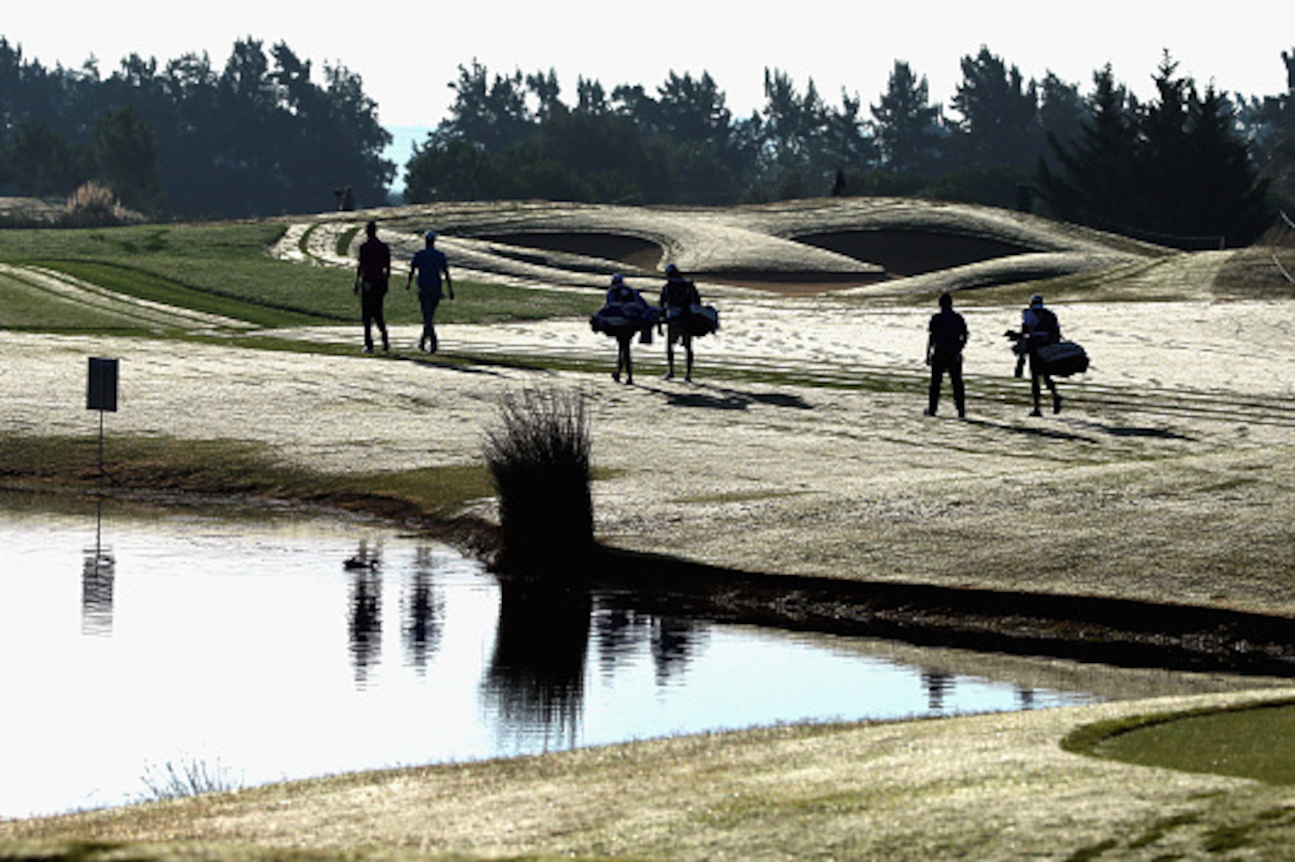 ALBUFEIRA, PORTUGAL - OCTOBER 16:  (L-R) The group of Chris Wood of England, Bernd Wiesberger of Austria and Alexander Levy of France walk towards the 12th fairway during the second round of the Portugal Masters at Oceanico Victoria Golf Club on October 1