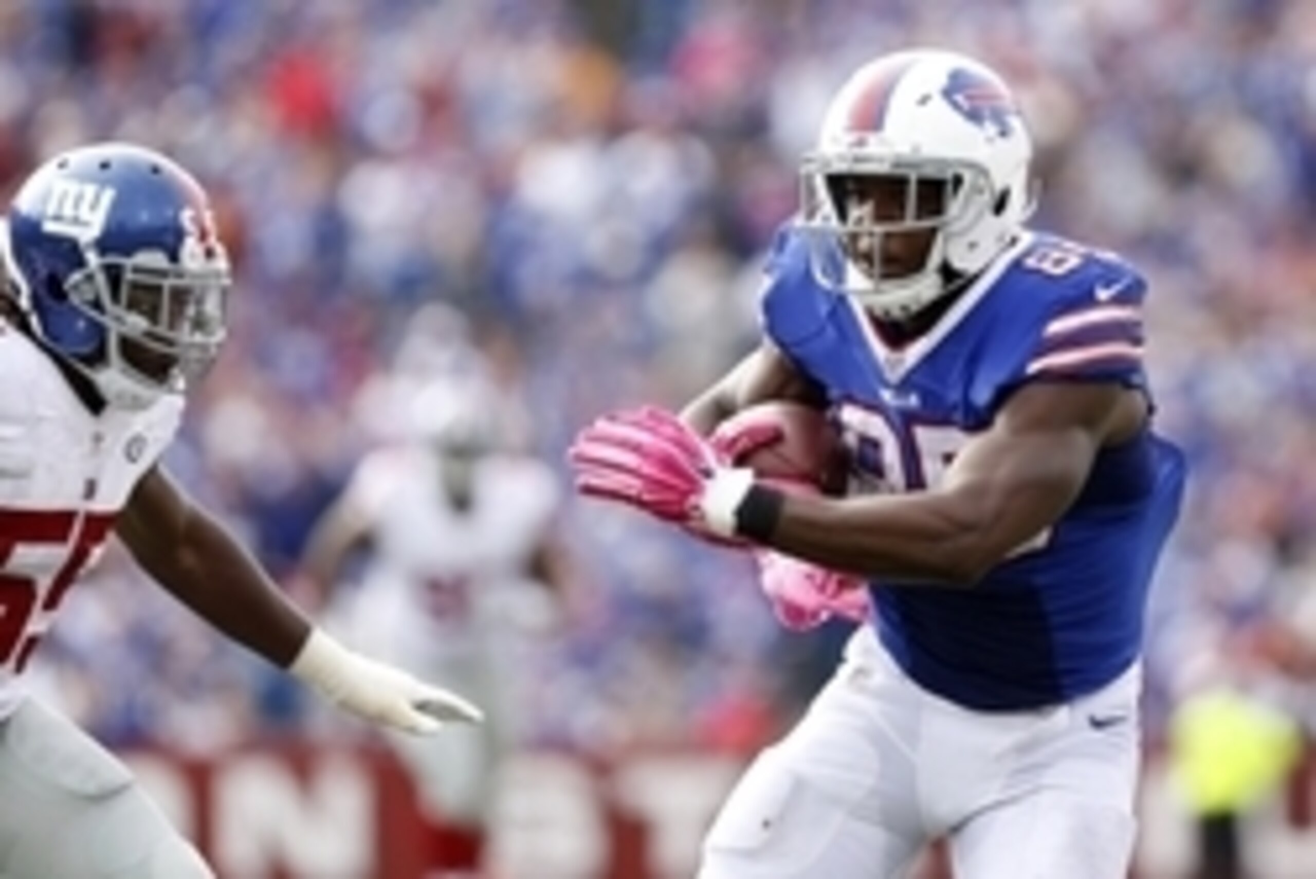 Oct 4, 2015; Orchard Park, NY, USA; Buffalo Bills tight end Charles Clay (85) runs after a catch as New York Giants outside linebacker J.T. Thomas (55) defends during the second half at Ralph Wilson Stadium. Giants beat the Bills 24-10. Mandatory Credit: