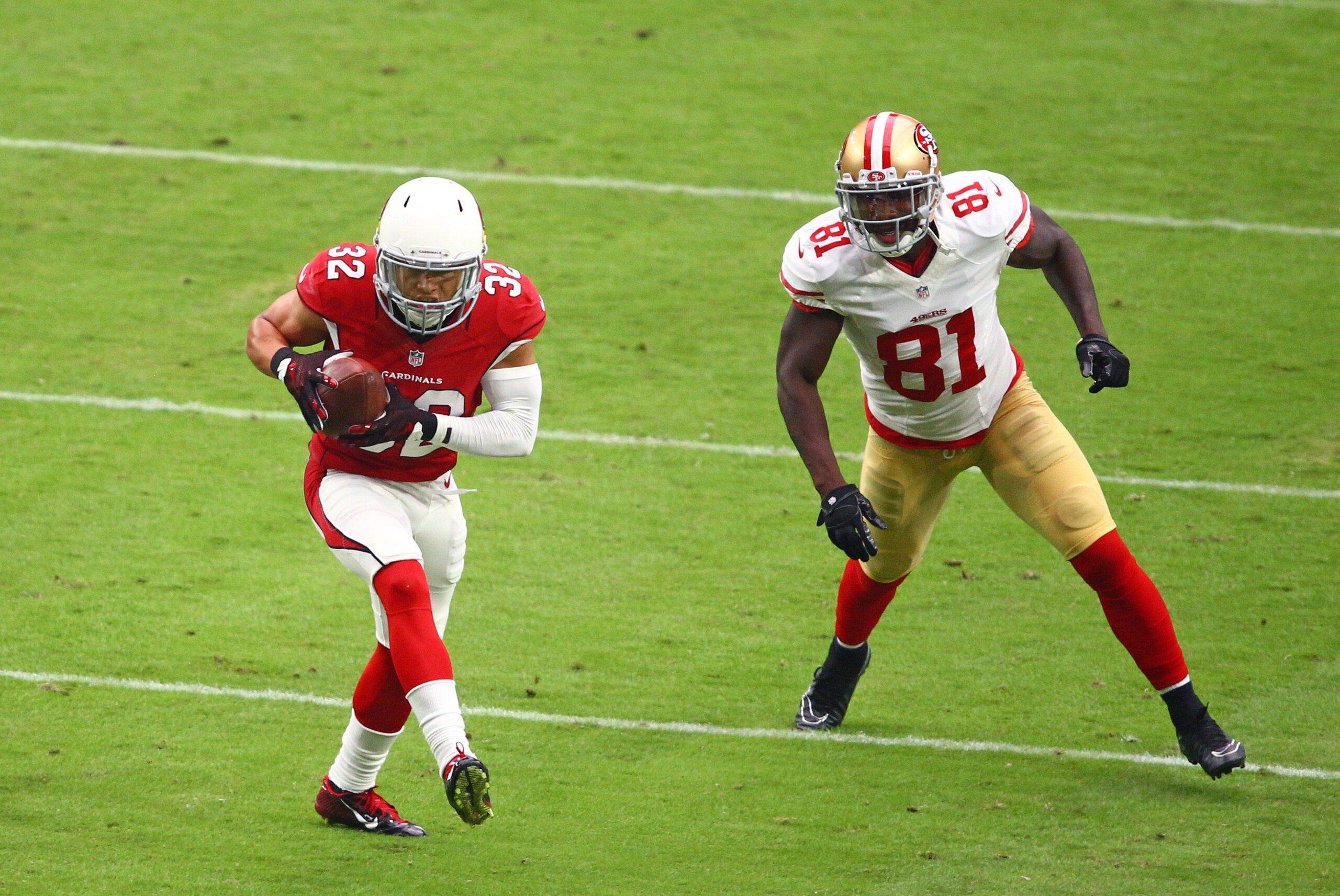Sep 27, 2015; Glendale, AZ, USA; Arizona Cardinals safety Tyrann Mathieu (32) intercepts a pass intended for San Francisco 49ers wide receiver Anquan Boldin (81) and returns it for a touchdown at University of Phoenix Stadium. Mandatory Credit: Mark J. Re
