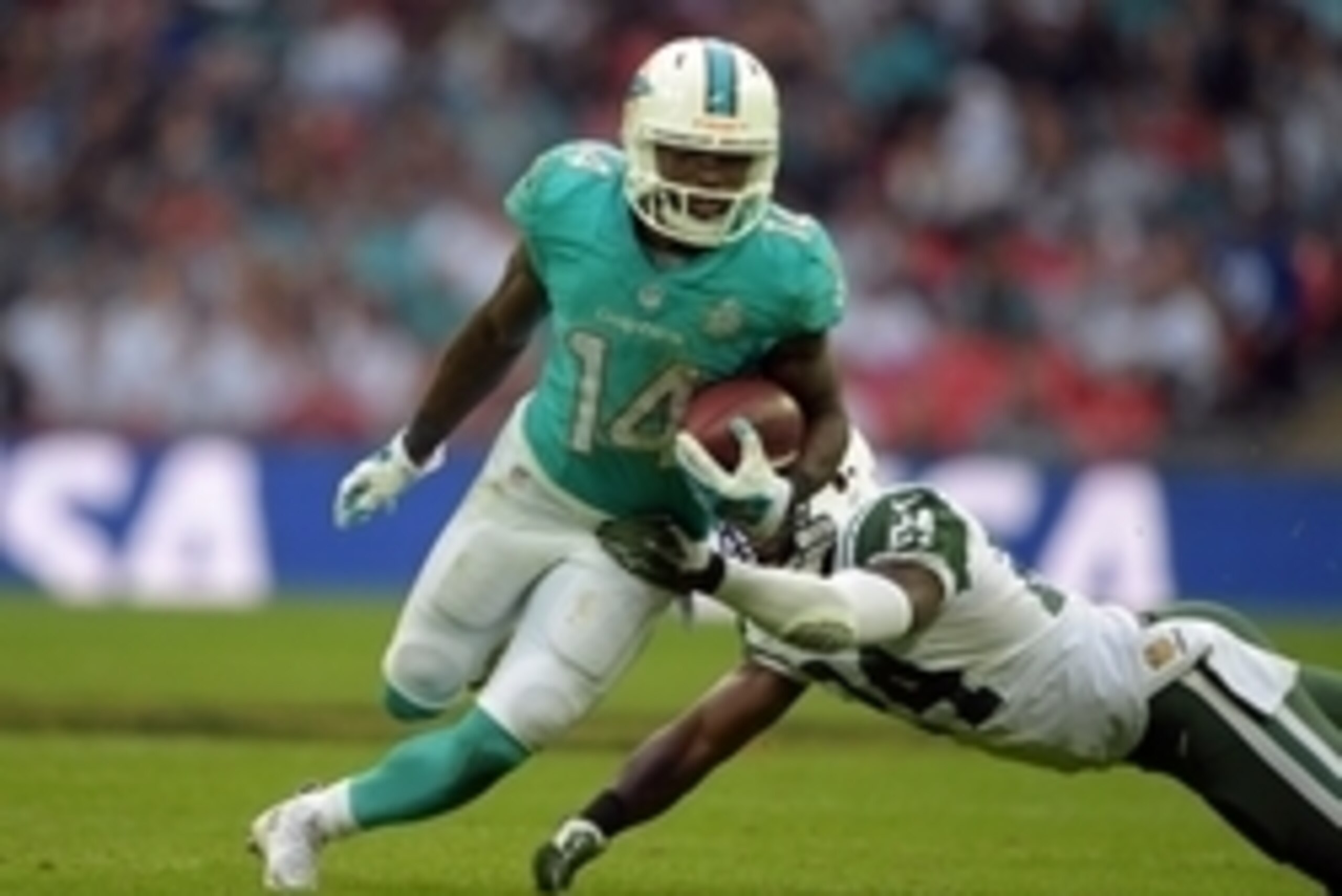 Oct 4, 2015; London, United Kingdom; Miami Dolphins receiver Jarvis Landry (14) is defended by New York Jets cornerback Darrelle Revis (24) in Game 12 of the NFL International Series at Wembley Stadium. The Jets defeated the Dolphins 27-14. Mandatory Cred