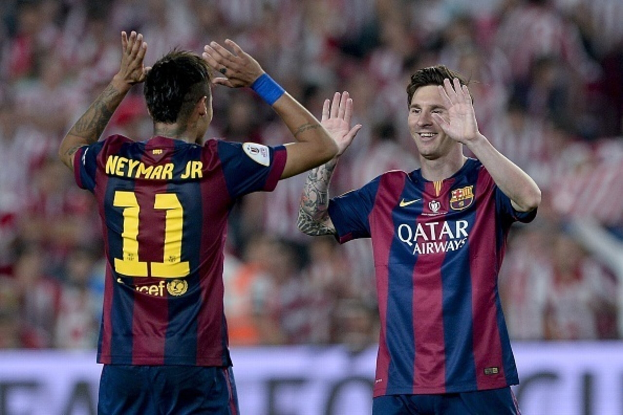 Barcelona's Brazilian forward Neymar da Silva Santos Junior (L) and Barcelona's Argentinian forward Lionel Messi celebrate their victory at the end of the Spanish Copa del Rey (King's Cup) final football match Athletic Club Bilbao vs FC Barcelona at the C