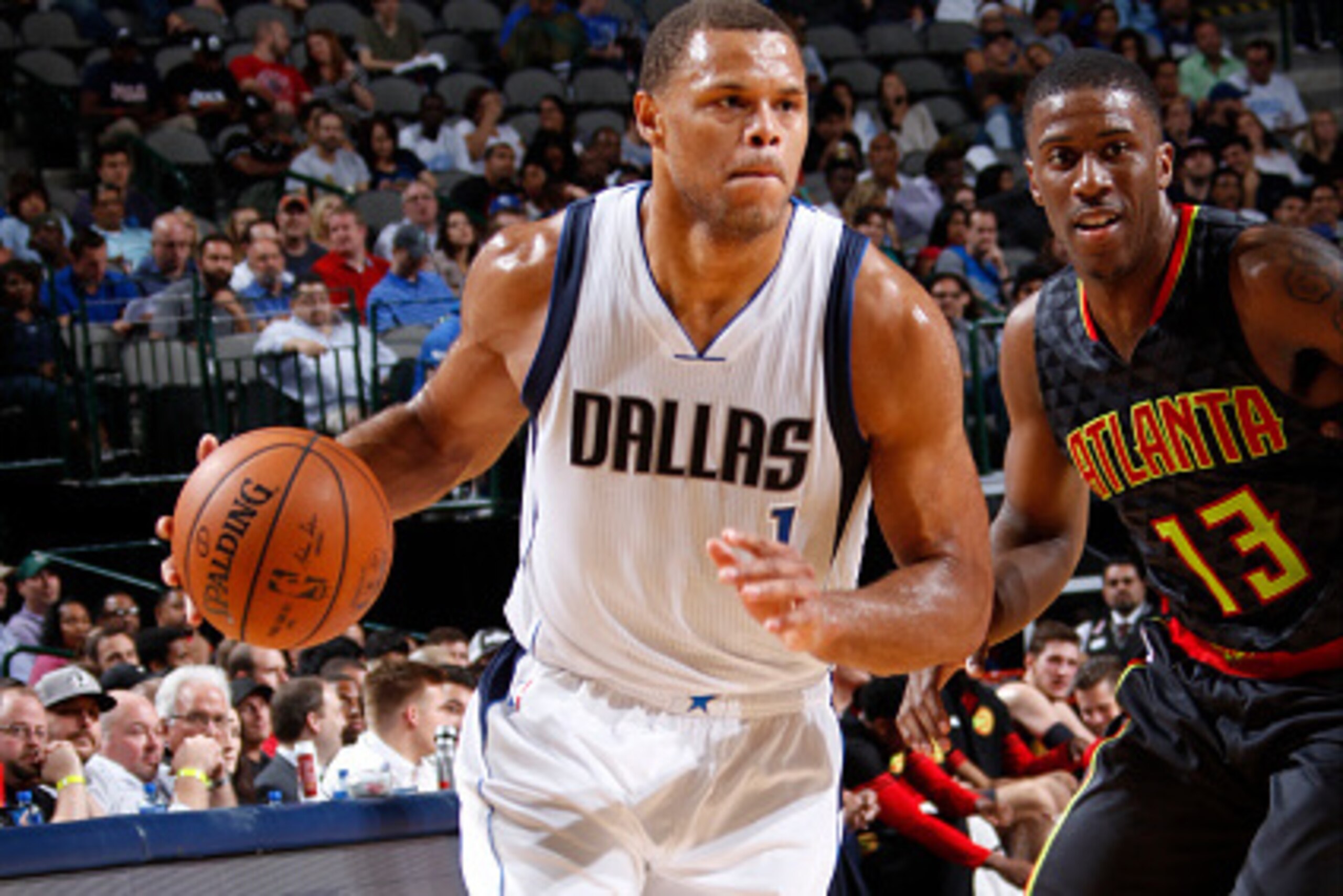 DALLAS, TX - OCTOBER 16: Justin Anderson #1 of the Dallas Mavericks handles the ball against Lamar Patterson #13 of the Atlanta Hawks on October 16, 2015 at the American Airlines Center in Dallas, Texas. NOTE TO USER: User expressly acknowledges and agree
