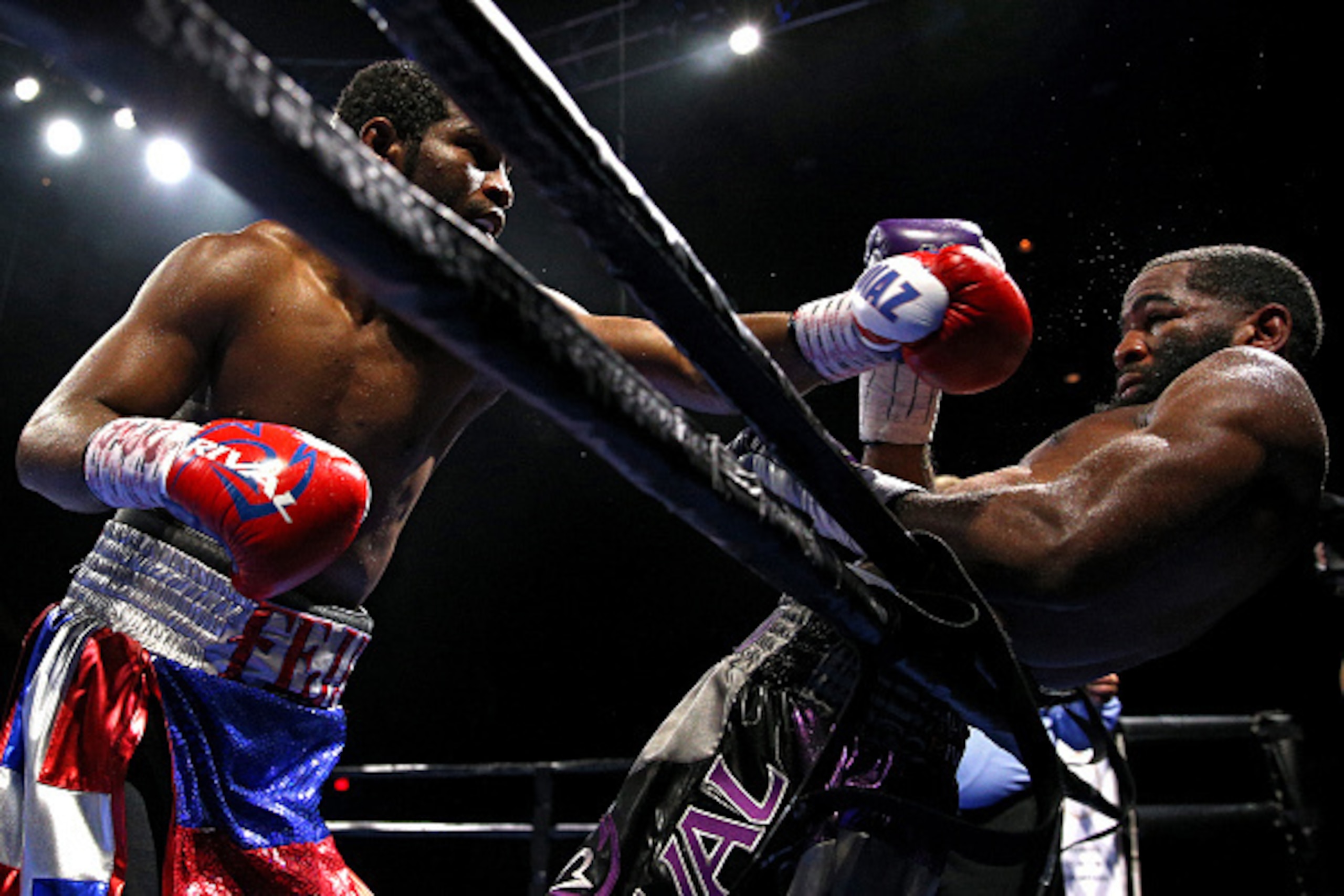 FAIRFAX, VA - OCTOBER 17: Felix Diaz Jr. punches Lamont Peterson during their welterweight bout on the campus of George Mason University on October 17, 2015 in Fairfax, Virginia. Peterson won on judges decision. (Photo by Patrick Smith/Getty Images)