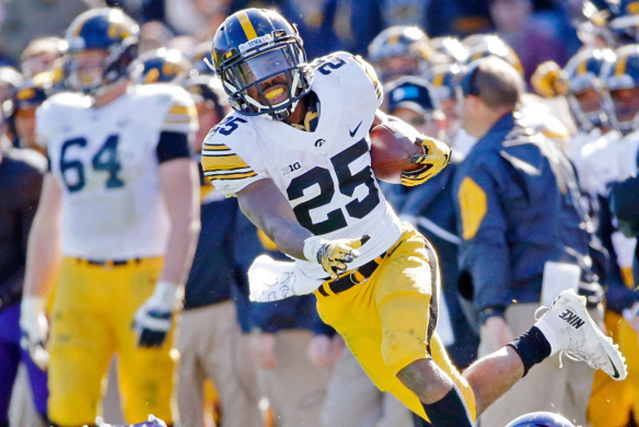 EVANSTON, IL - OCTOBER 17: Jake Murray #10 of the Northwestern Wildcats tackles Akrum Wadley #25 of the Iowa Hawkeyes during the second half at Ryan Field on October 17, 2015 in Evanston, Illinois. Iowa Hawkeyes won 40-10. (Photo by Jon Durr/Getty Images)