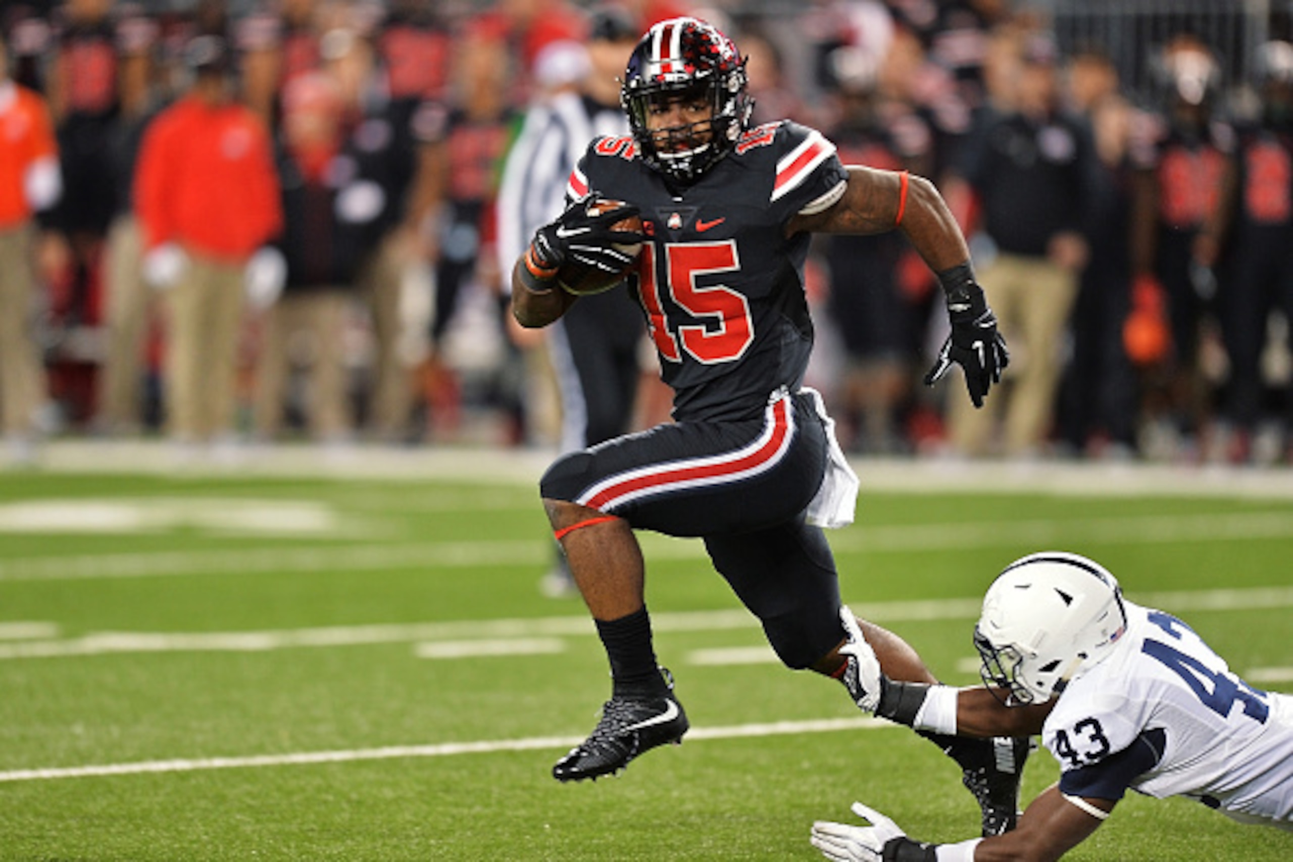 COLUMBUS, OH - OCTOBER 17:  Ezekiel Elliott #15 of the Ohio State Buckeyes eludes a tackle attempt from Manny Bowen #43 of the Penn State Nittany Lions on his way to a 10-yard touchdown run in the second quarter at Ohio Stadium on October 17, 2015 in Colu