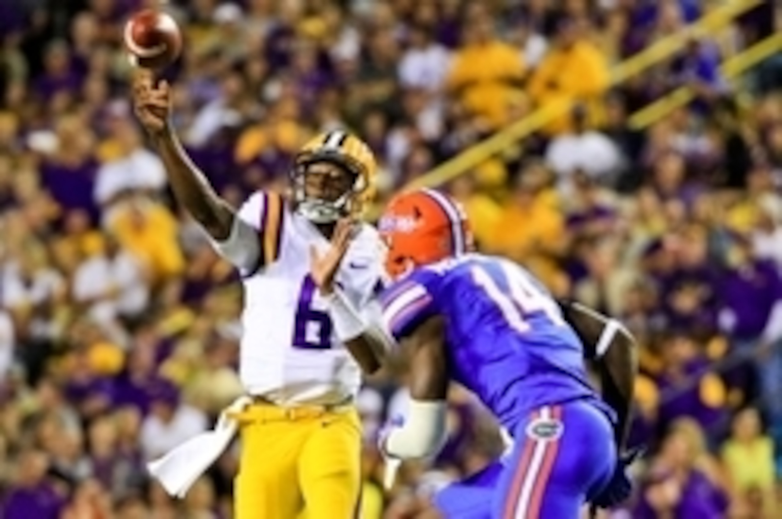 Oct 17, 2015; Baton Rouge, LA, USA; LSU Tigers quarterback Brandon Harris (6) throws as Florida Gators defensive lineman Alex McCalister (14) defends during the second quarter of a game at Tiger Stadium. Mandatory Credit: Derick E. Hingle-USA TODAY Sports