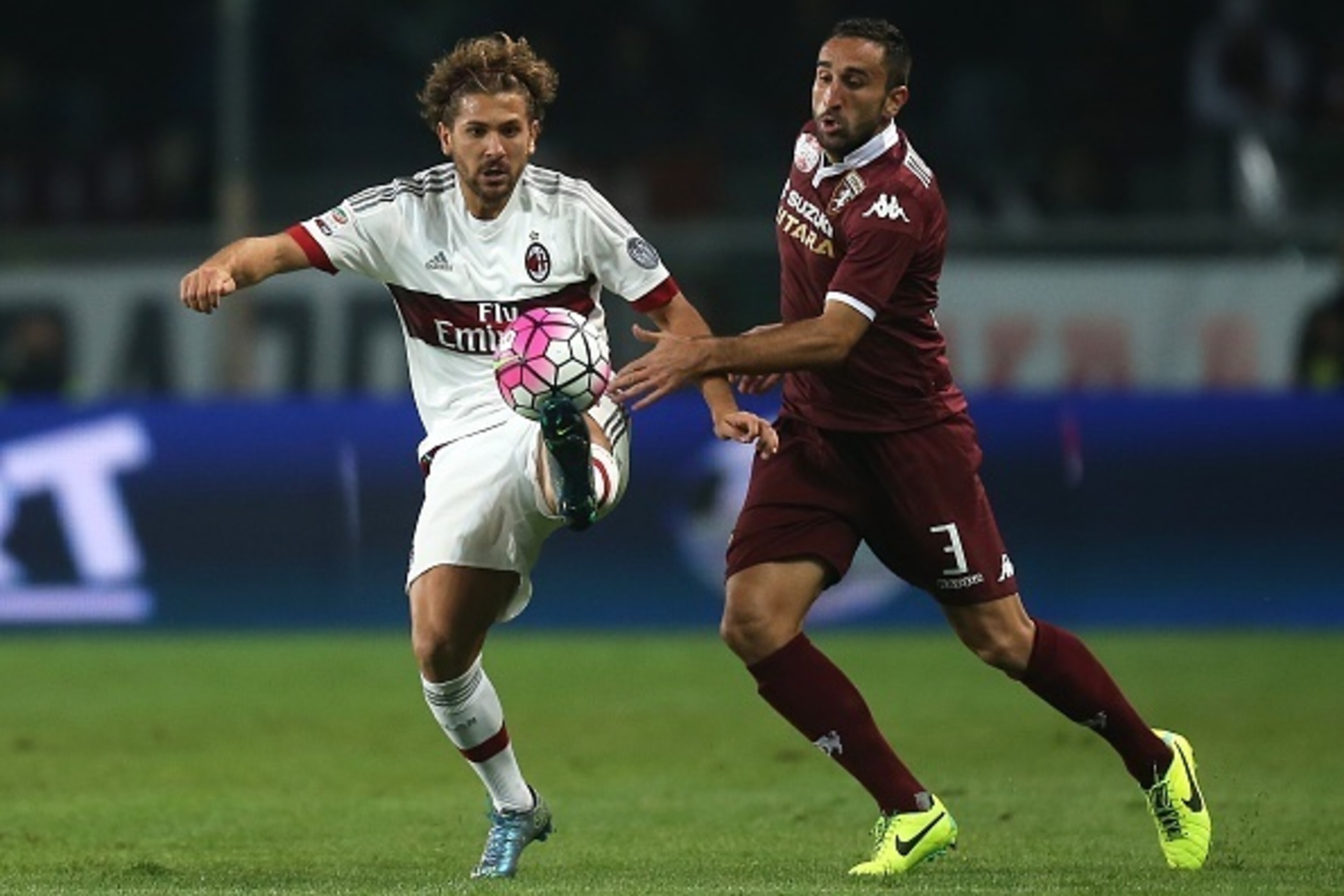 AC Milan's forward Alessio Cerci (L) fights for the ball with Torino's defender Cristian Molinaro during the Italian Serie A football match Torino Vs AC Milan on October 17, 2015 at the 'Olympic Stadium' in Turin.  AFP PHOTO / MARCO BERTORELLO        (Pho