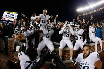 ANN ARBOR, MI - OCTOBER 17:  The Michigan State Spartans celebrate after defeating the Michigan Wolverines 27-23 in the college football game at Michigan Stadium on October 17, 2015 in Ann Arbor, Michigan.  (Photo by Christian Petersen/Getty Images)