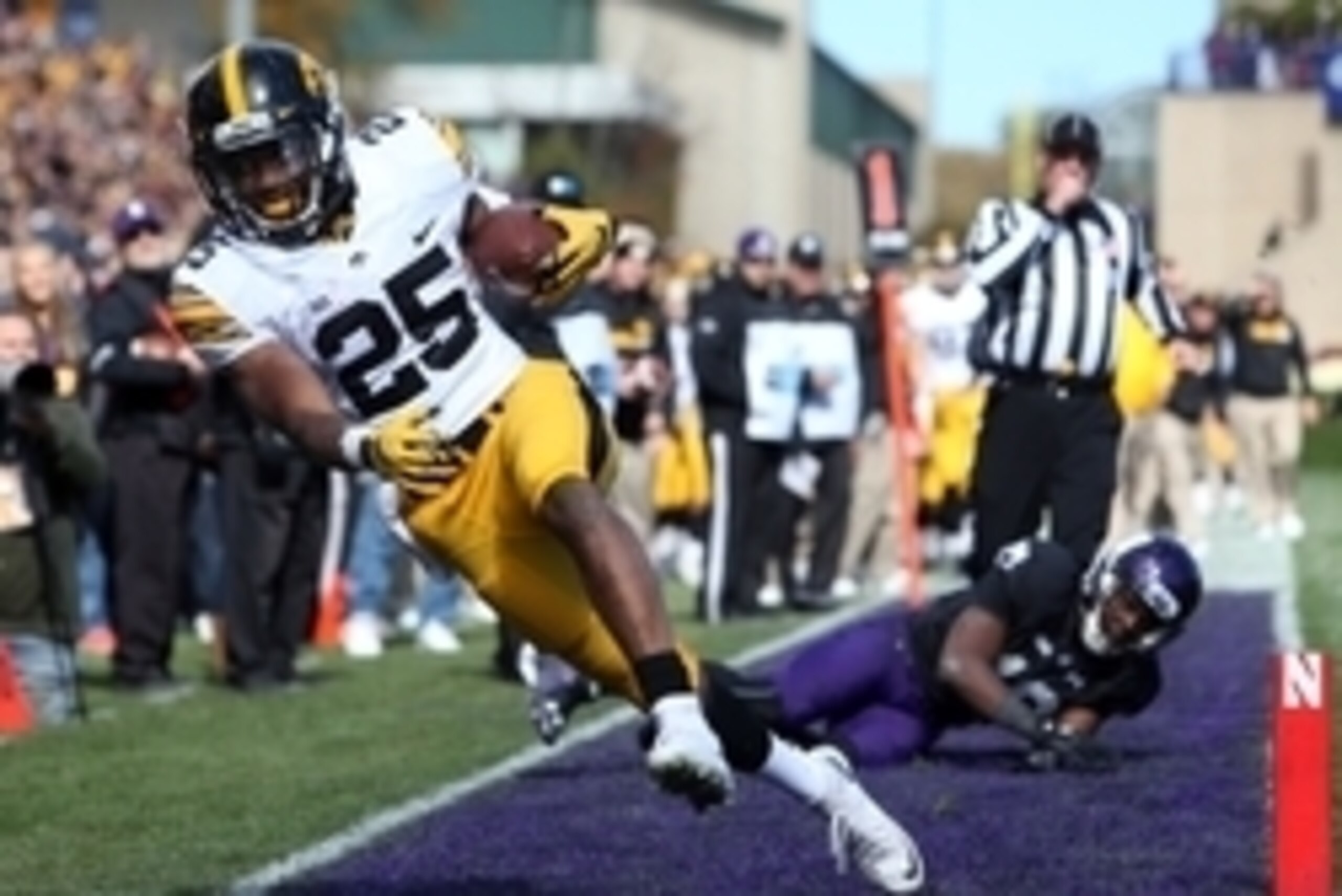 Oct 17, 2015; Evanston, IL, USA; Iowa Hawkeyes running back Akrum Wadley (25) is pushed out of bounds short of the goal line by Northwestern Wildcats safety Godwin Igwebuike (16) during the first half at Ryan Field. Mandatory Credit: Jerry Lai-USA TODAY S