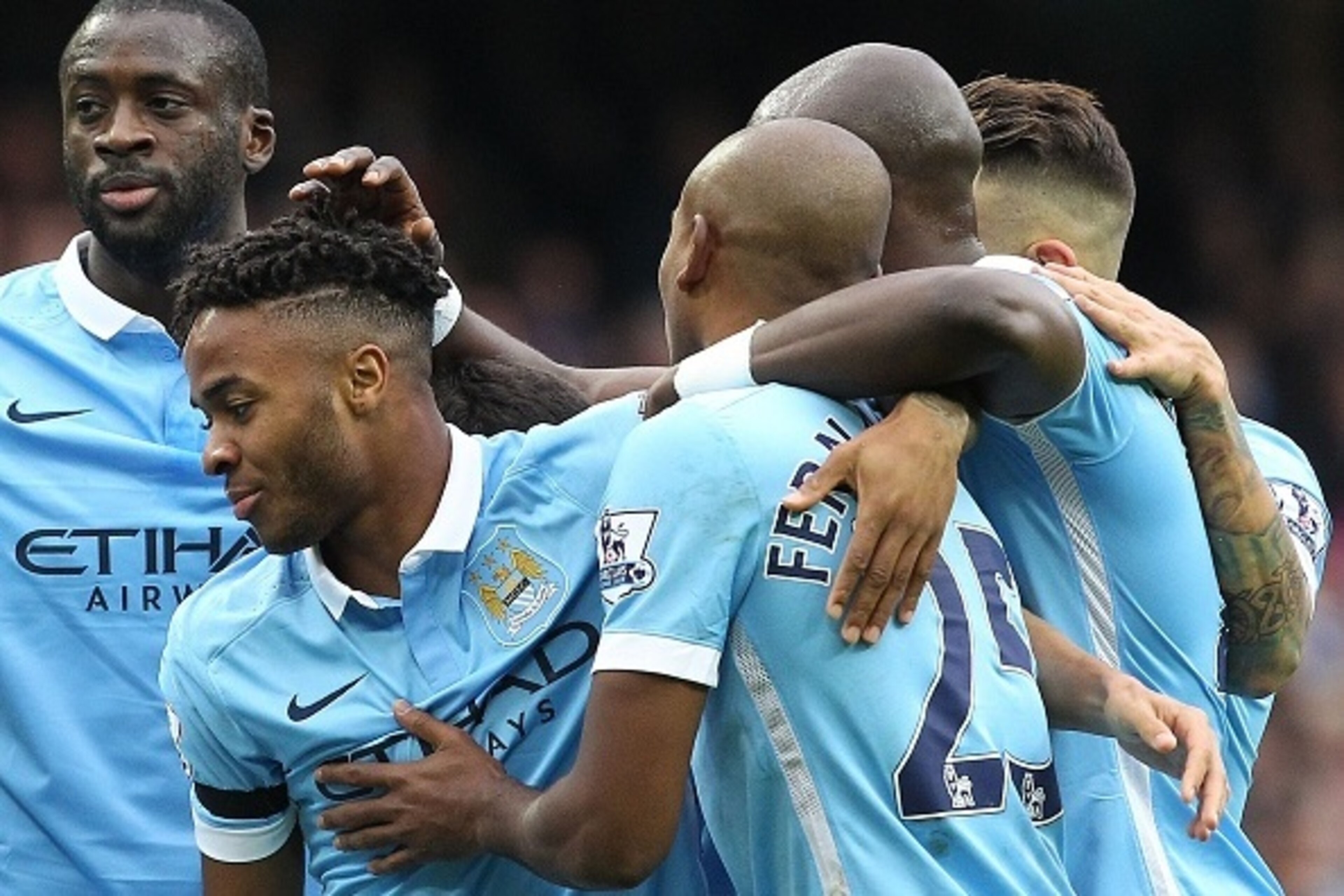 Manchester City's English midfielder Raheem Sterling (2nd L) celebrates with teammates after scoring the opening goal of the English Premier League football match between Manchester City and Bournemouth at the Etihad Stadium in Manchester, northwest Engla