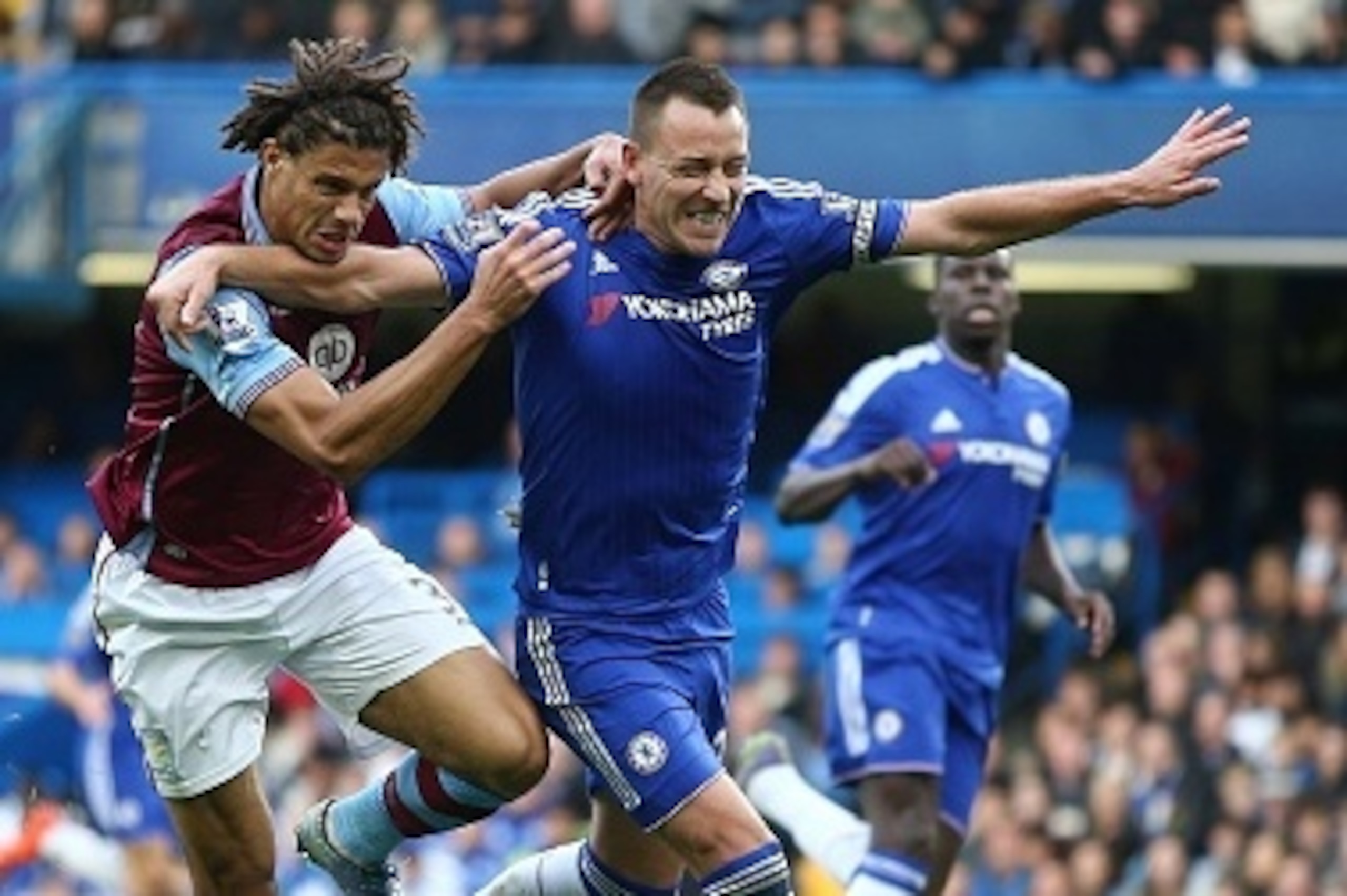 Aston Villa's Benin striker Rudy Gestede (L) vies for the ball with Chelsea's English defender John Terry during the English Premier League football match between Chelsea and Aston Villa at Stamford Bridge in London, on October 17, 2015. AFP PHOTO / JUSTI