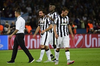 (2nd L-R) Juventus' midfielder Andrea Pirlo, Juventus' French midfielder Paul Pogba and Juventus' midfielder Claudio Marchisio react after the UEFA Champions League Final football match between Juventus and FC Barcelona at the Olympic Stadium in Berlin on