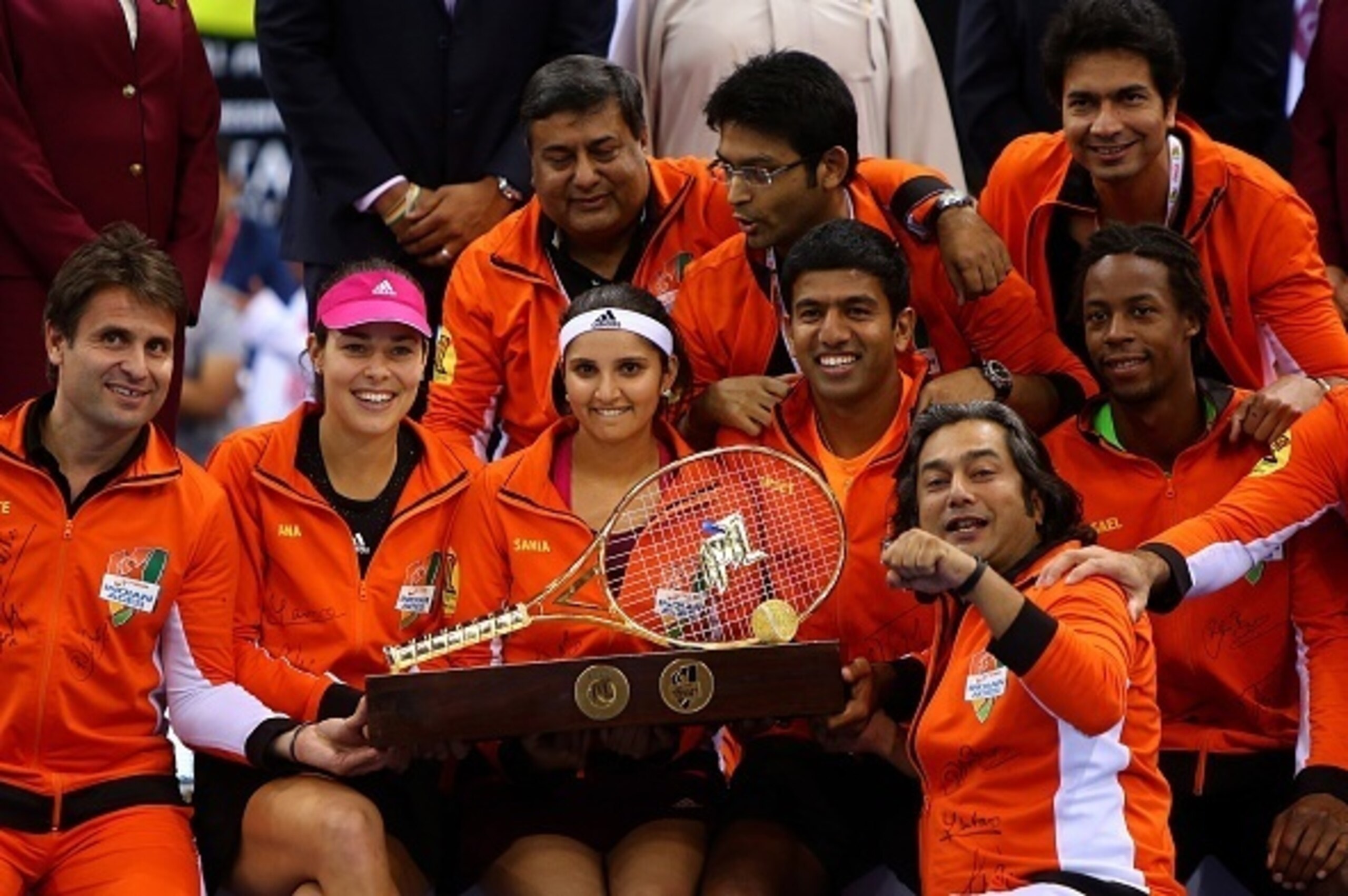 Players of the Indian Aces team pose with their trophy after winning the Coca-Cola International Premier Tennis League (IPTL) tournament at the Hamdan Sports Complex in Dubai on December 13, 2014. AFP PHOTO / MARWAN NAAMANI        (Photo credit should rea