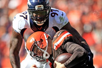 CLEVELAND, OH - OCTOBER 18: Quarterback Josh McCown #13 of the Cleveland Browns is tackled by defensive end Malik Jackson #97 of the Denver Broncos during the second quarter at Cleveland Browns Stadium on October 18, 2015 in Cleveland, Ohio.  (Photo by An