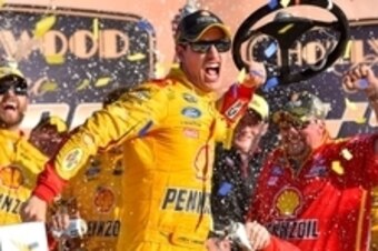 Oct 18, 2015; Kansas City, KS, USA; NASCAR Sprint Cup Series driver Joey Logano celebrates in victory lane after winning the Hollywood Casino 400 at Kansas Speedway. Mandatory Credit: Jasen Vinlove-USA TODAY Sports