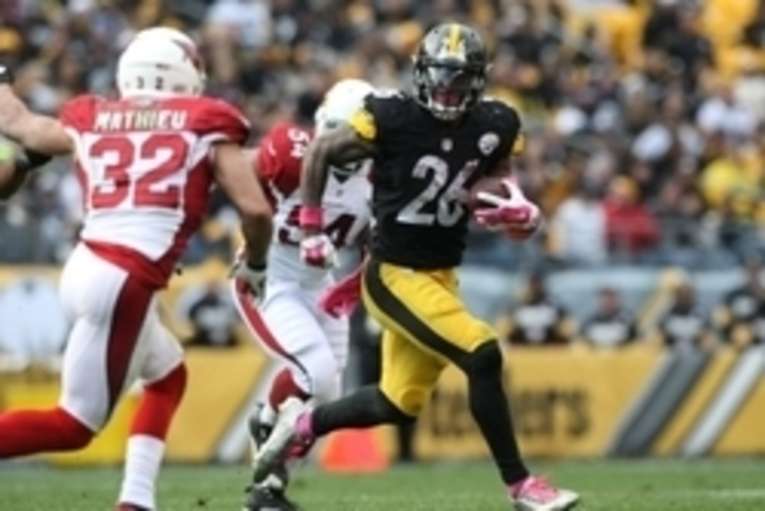 Oct 18, 2015; Pittsburgh, PA, USA; Pittsburgh Steelers running back Le'Veon Bell (26) runs the ball against Arizona Cardinals safety Tyrann Mathieu (32) during the second half at Heinz Field. The Steelers won the game, 25-13. Mandatory Credit: Jason Bridg
