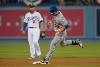 Oct 10, 2015; Los Angeles, CA, USA; New York Mets left fielder Michael Conforto (30) rounds the bases after hitting a solo home run during the second inning in game two of the NLDS against Los Angeles Dodgers third baseman Justin Turner (10) at Dodger Sta