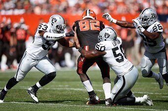 CLEVELAND, OH - SEPTEMBER 27:  Gary Barnidge #82 of the Cleveland Browns is stopped by the defense of Malcolm Smith #53, Curtis Lofton #50 and D.J. Hayden #25 of the Oakland Raiders during the second quarter at FirstEnergy Stadium on September 27, 2015 in