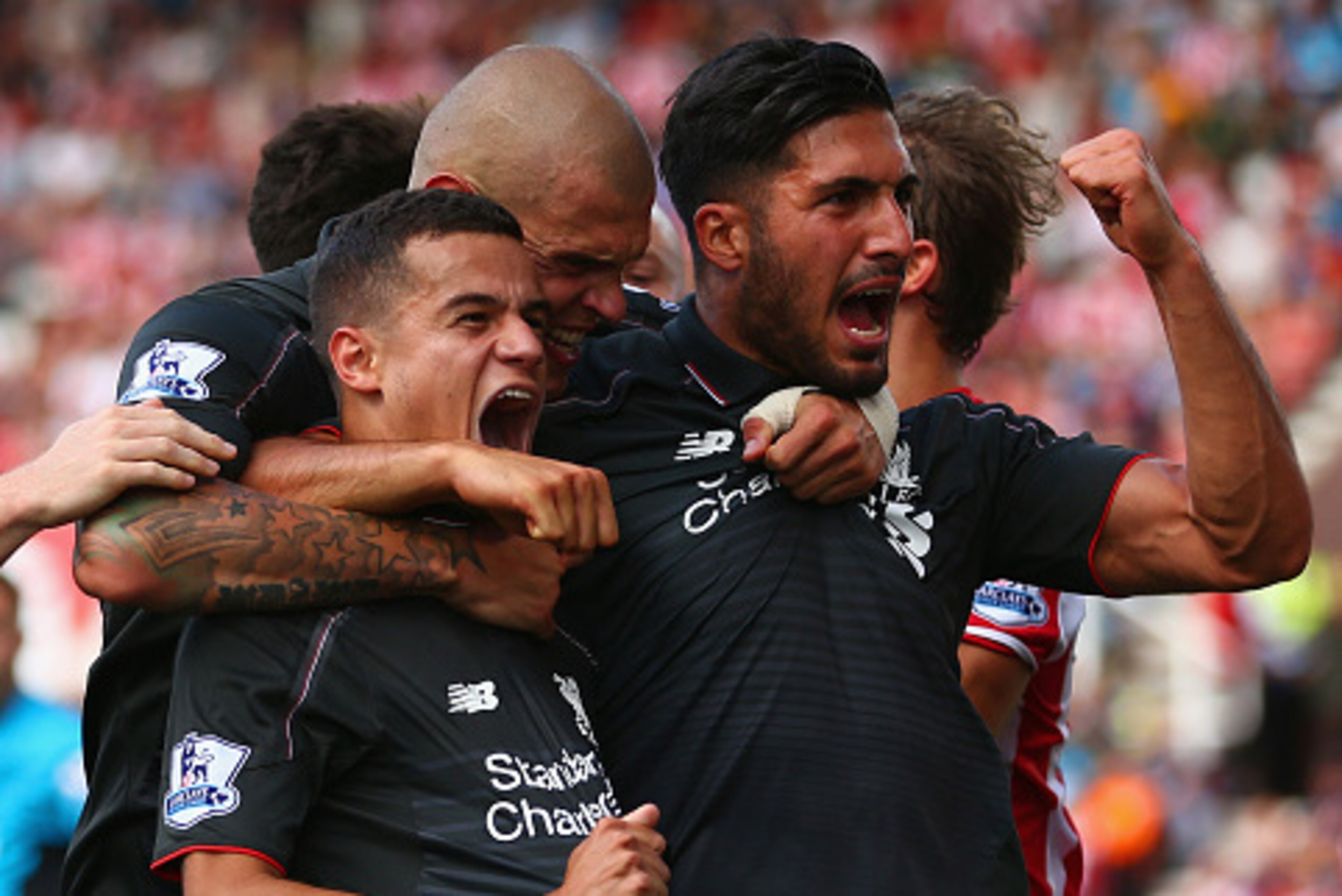 STOKE ON TRENT, ENGLAND - AUGUST 09: Philippe Coutinho of Liverpool (10) celebrates with team mates Martin Skrtel and Emre Can as he scores their first goal during the Barclays Premier League match between Stoke City and Liverpool at Brittania Stadium on STOKE ON TRENT, ENGLAND - AUGUST 09: Philippe Coutinho of Liverpool (10) celebrates with team mates Martin Skrtel and Emre Can as he scores their first goal during the Barclays Premier League match between Stoke City and Liverpool at Brittania Stadium on