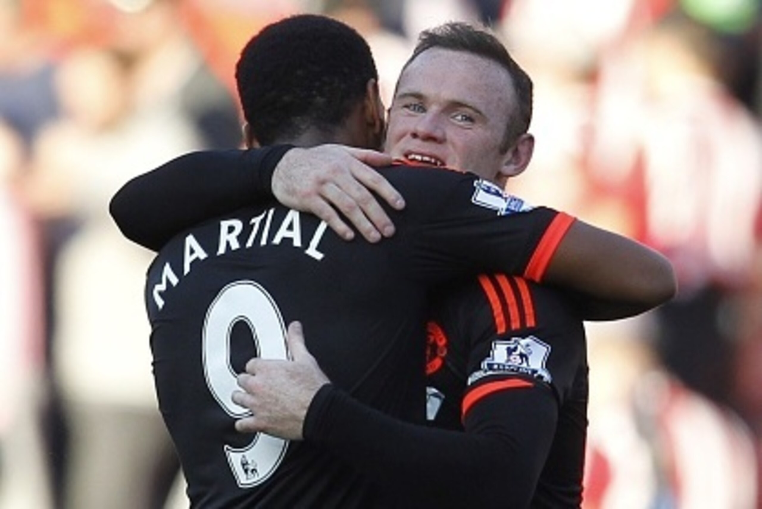 Manchester United's English striker Wayne Rooney embraces Manchester United's French striker Anthony Martial (L) after the English Premier League football match between Southampton and Manchester United at St Mary's Stadium in Southampton, southern Englan
