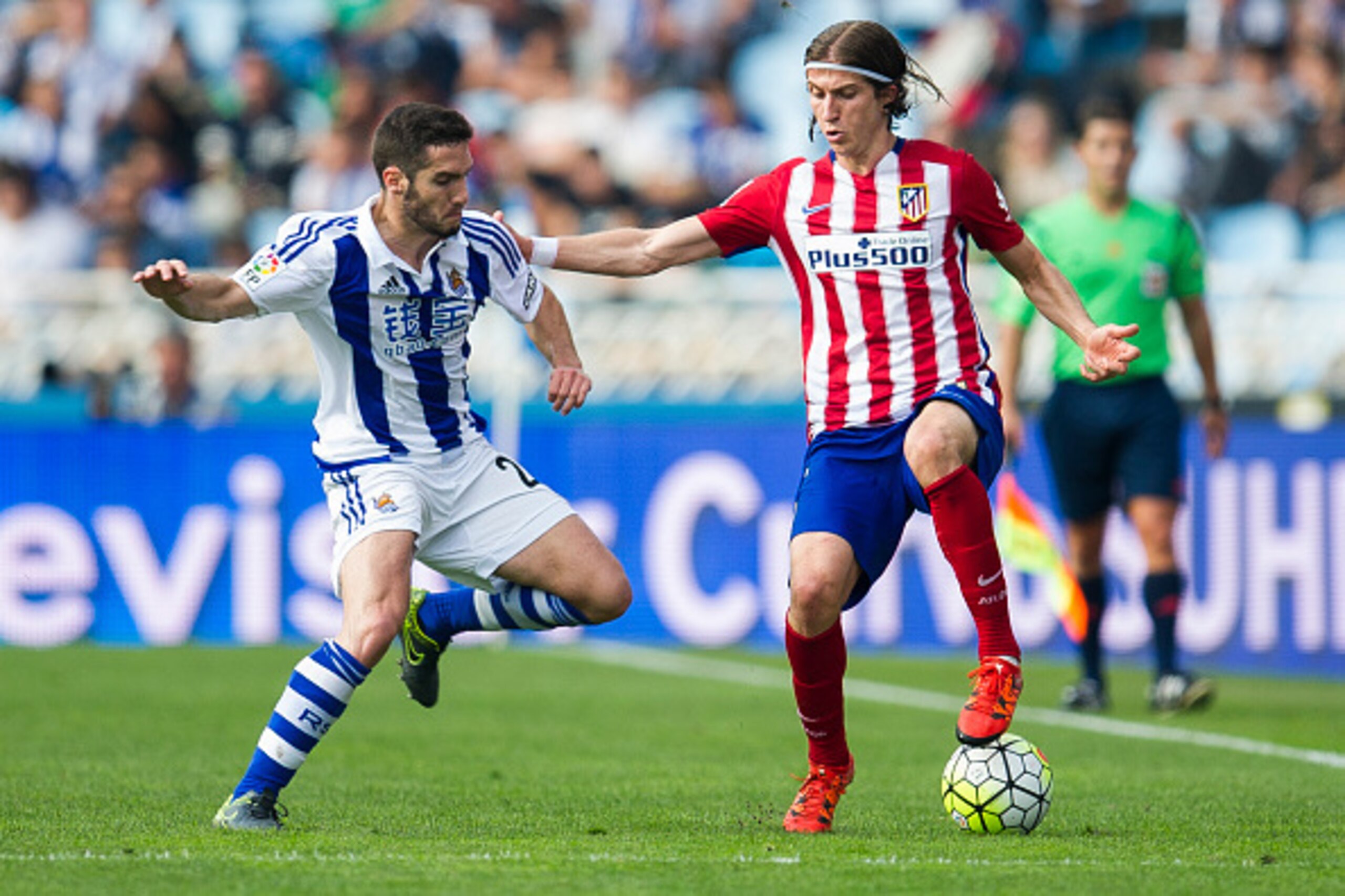 SAN SEBASTIAN, SPAIN - OCTOBER 18:  Filipe Luis of Atletico de Madrid duels for the ball with Inigo Martinez of Real Sociedad during the La Liga match between Real Sociedad de Futbol and Atletico de Madrid at Estadio Anoeta on October 18, 2015 in San Seba