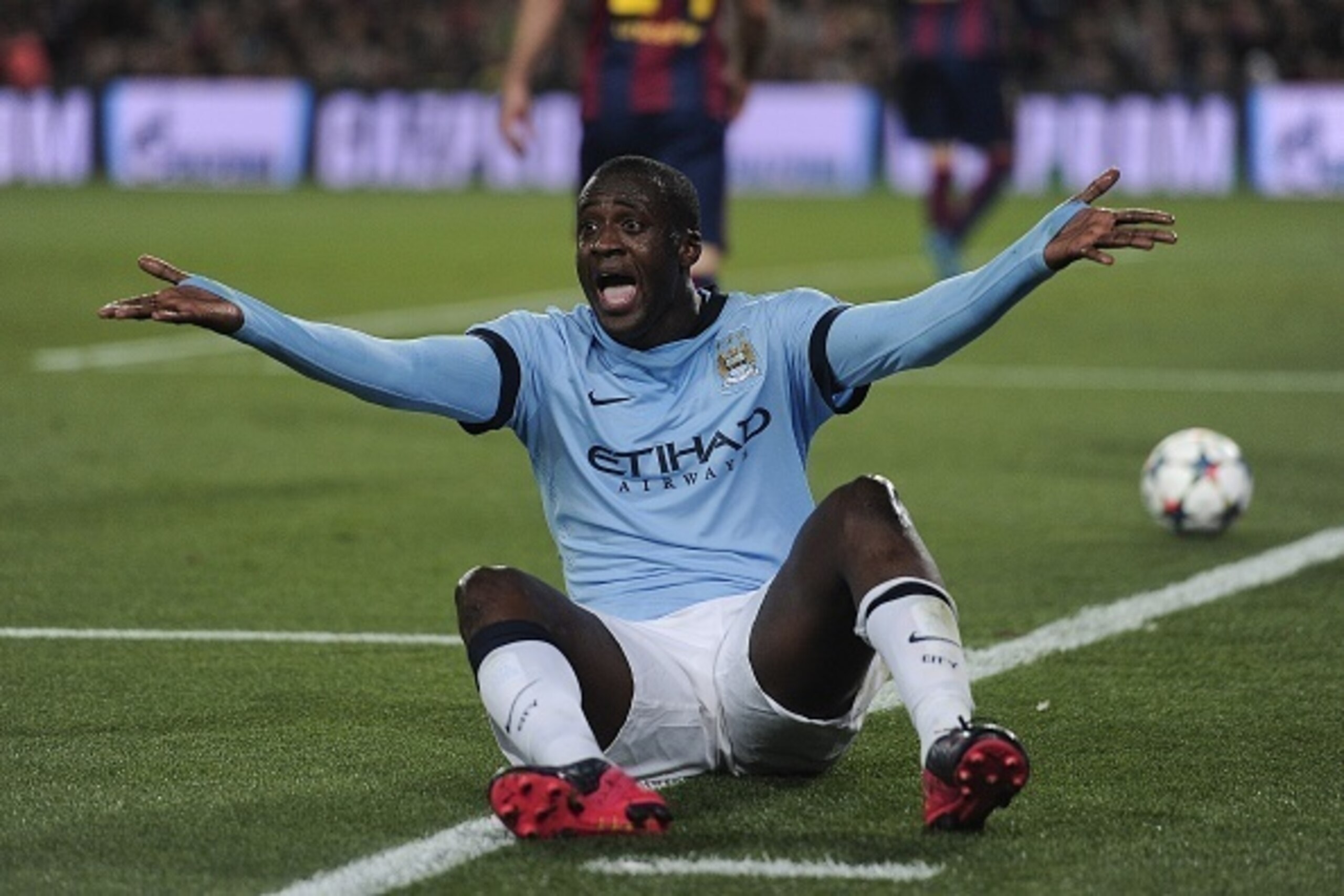 Manchester City's Ivorian midfielder Yaya Toure gestures from the ground during the UEFA Champions League round of 16 football match FC Barcelona vs Manchester City at the Camp Nou stadium in Barcelona on March 18, 2015. AFP PHOTO/ JOSEP LAGO        (Phot