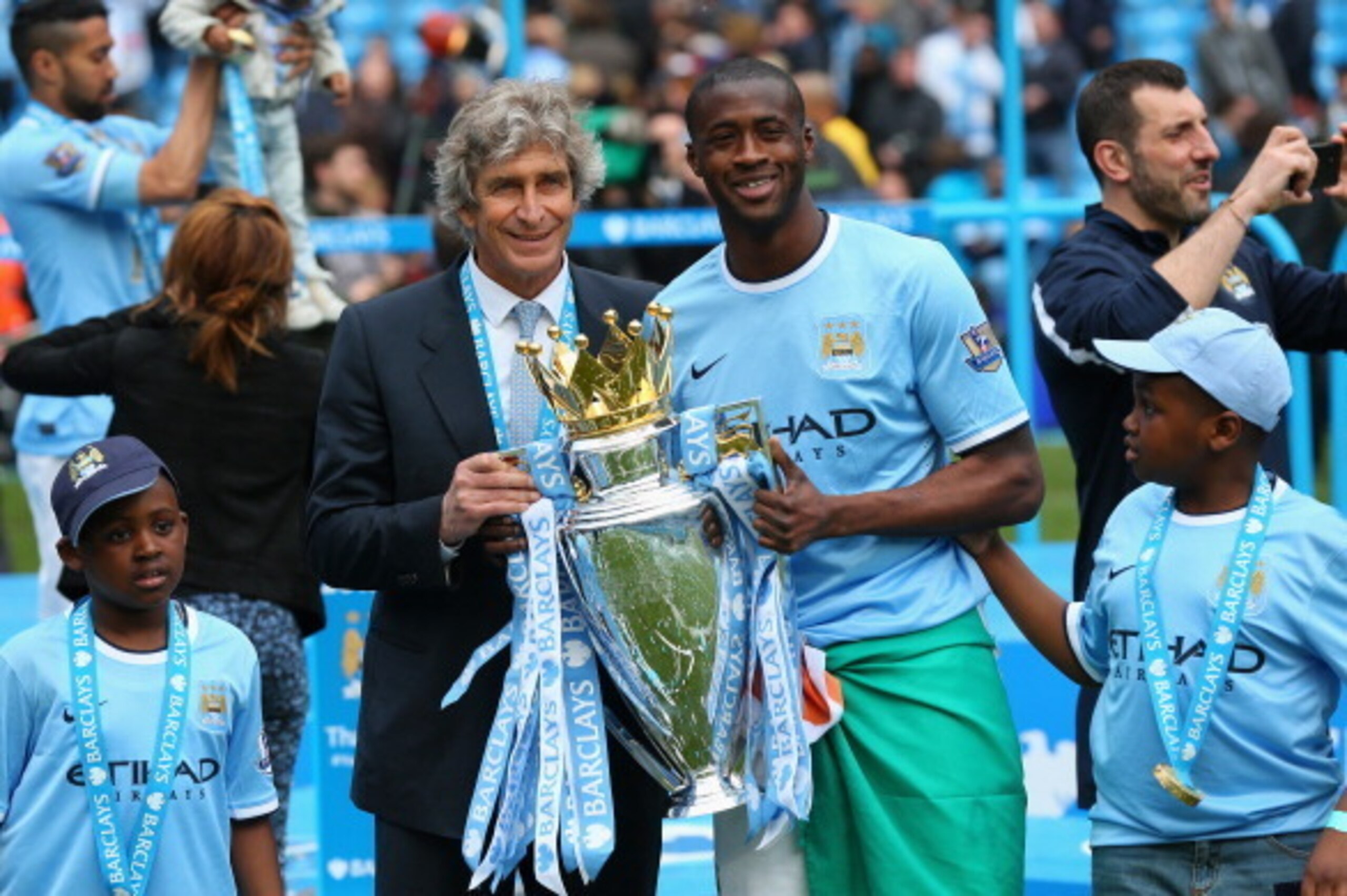 MANCHESTER, ENGLAND - MAY 11:  The Manchester City Manager Manuel Pellegrini and Yaya Toure pose with the trophy at the end of the Barclays Premier League match between Manchester City and West Ham United at the Etihad Stadium on May 11, 2014 in Mancheste