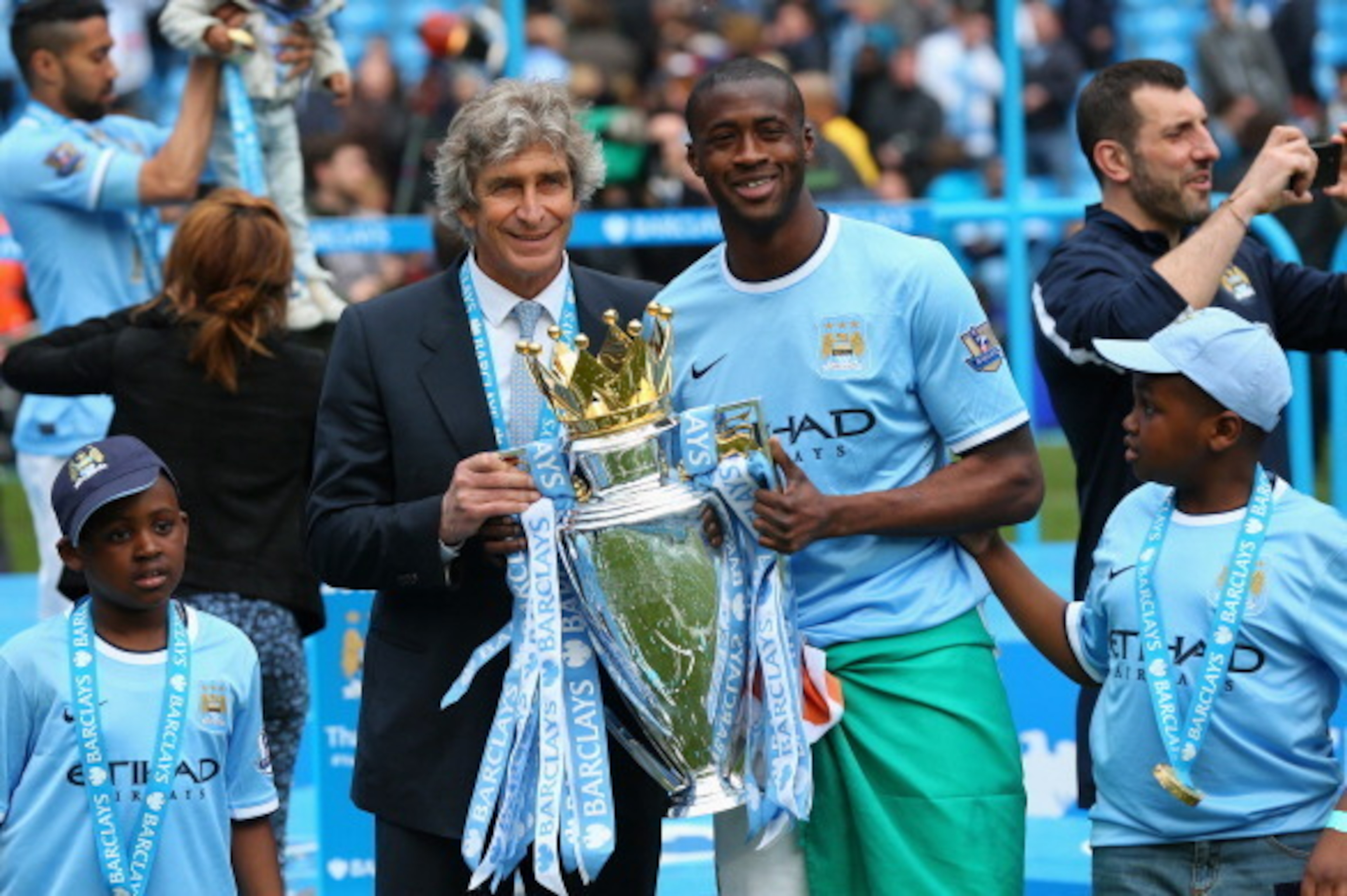 MANCHESTER, ENGLAND - MAY 11:  The Manchester City Manager Manuel Pellegrini and Yaya Toure pose with the trophy at the end of the Barclays Premier League match between Manchester City and West Ham United at the Etihad Stadium on May 11, 2014 in Mancheste