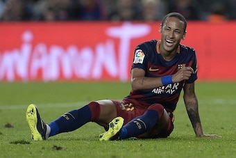 Barcelona's Brazilian forward Neymar da Silva Santos Junior smiles as he sits on the field during the Spanish league football match FC Barcelona vs Rayo Vallecano de Madrid at the Camp Nou stadium in Barcelona on October 17, 2015.   AFP PHOTO/ JOSEP LAGO 