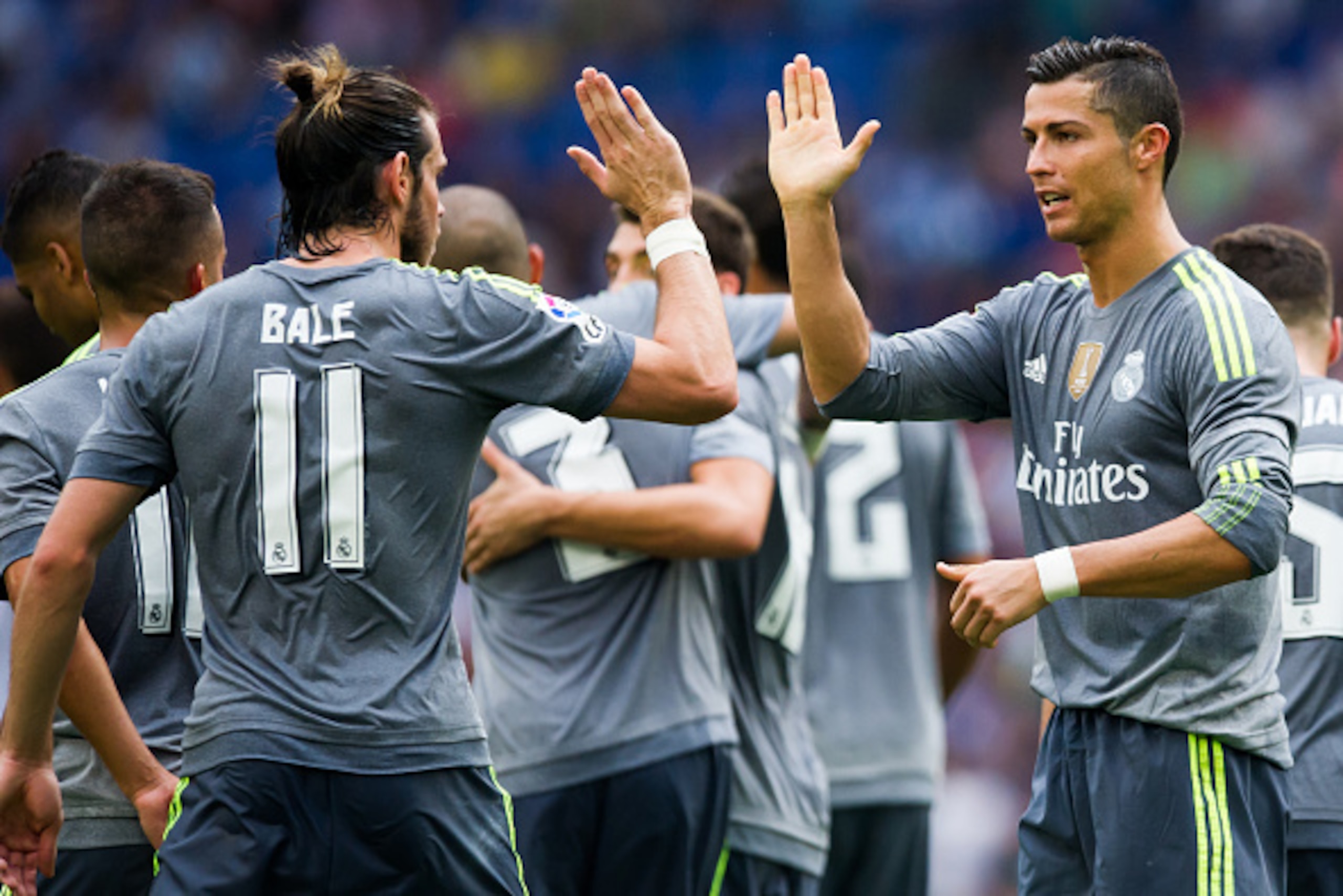 BARCELONA, SPAIN - SEPTEMBER 12: Cristiano Ronaldo (R) of Real Madrid CF is congratulated by his teammate Gareth Bale (L) after scoring his team's sixth goal during the La Liga match between RCD Espanyol and Real Madrid CF at Cornella-El Prat Stadium on S