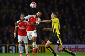 WATFORD, ENGLAND - OCTOBER 17:  Theo Walcott of Arsenal and Craig Cathcart of Watford compete for the bal during the Barclays Premier League match between Watford and Arsenal at Vicarage Road on October 17, 2015 in Watford, England.  (Photo by Ross Kinnai