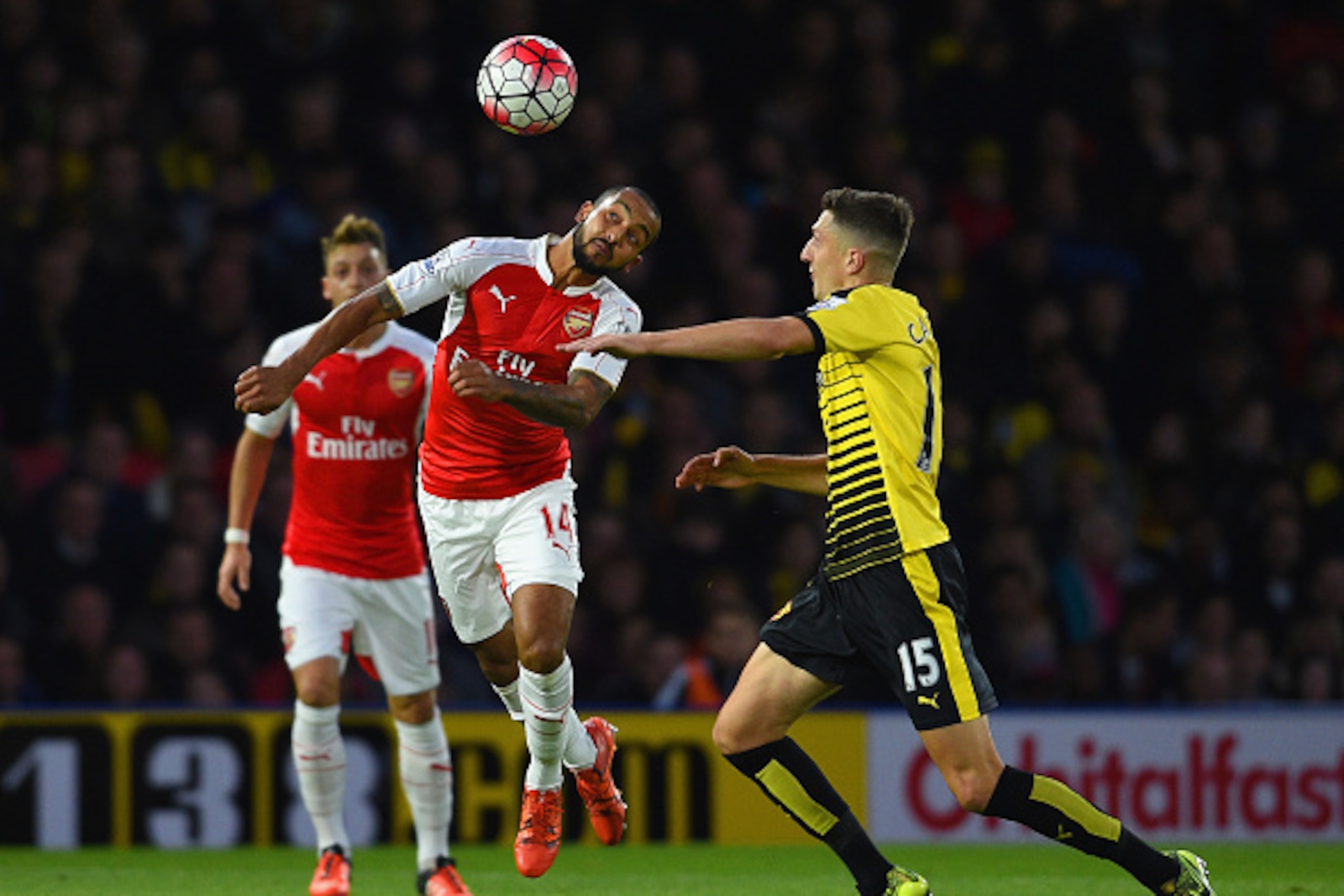 WATFORD, ENGLAND - OCTOBER 17:  Theo Walcott of Arsenal and Craig Cathcart of Watford compete for the bal during the Barclays Premier League match between Watford and Arsenal at Vicarage Road on October 17, 2015 in Watford, England.  (Photo by Ross Kinnai